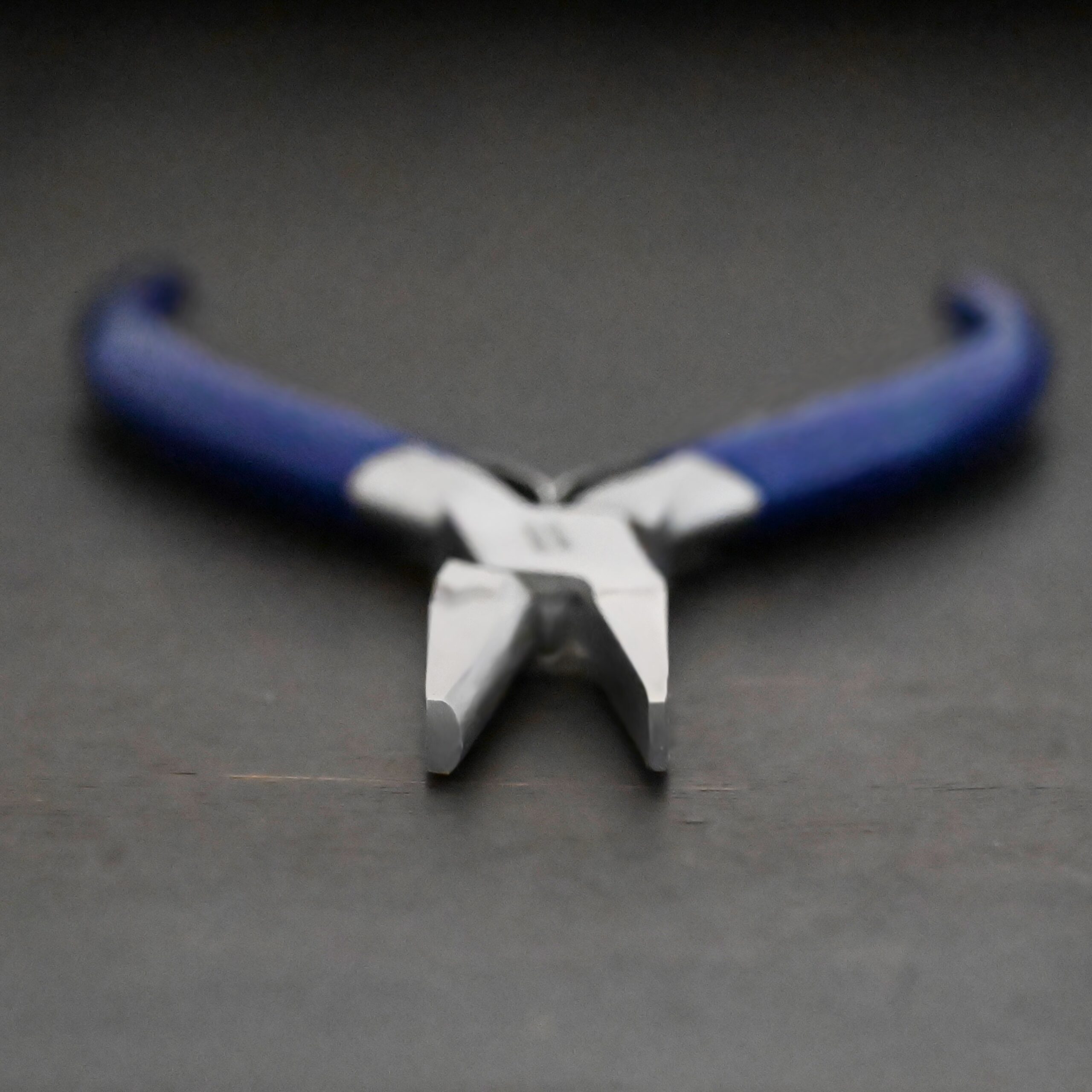 Ring Bending Pliers - Blue rubber handle shown on dark background