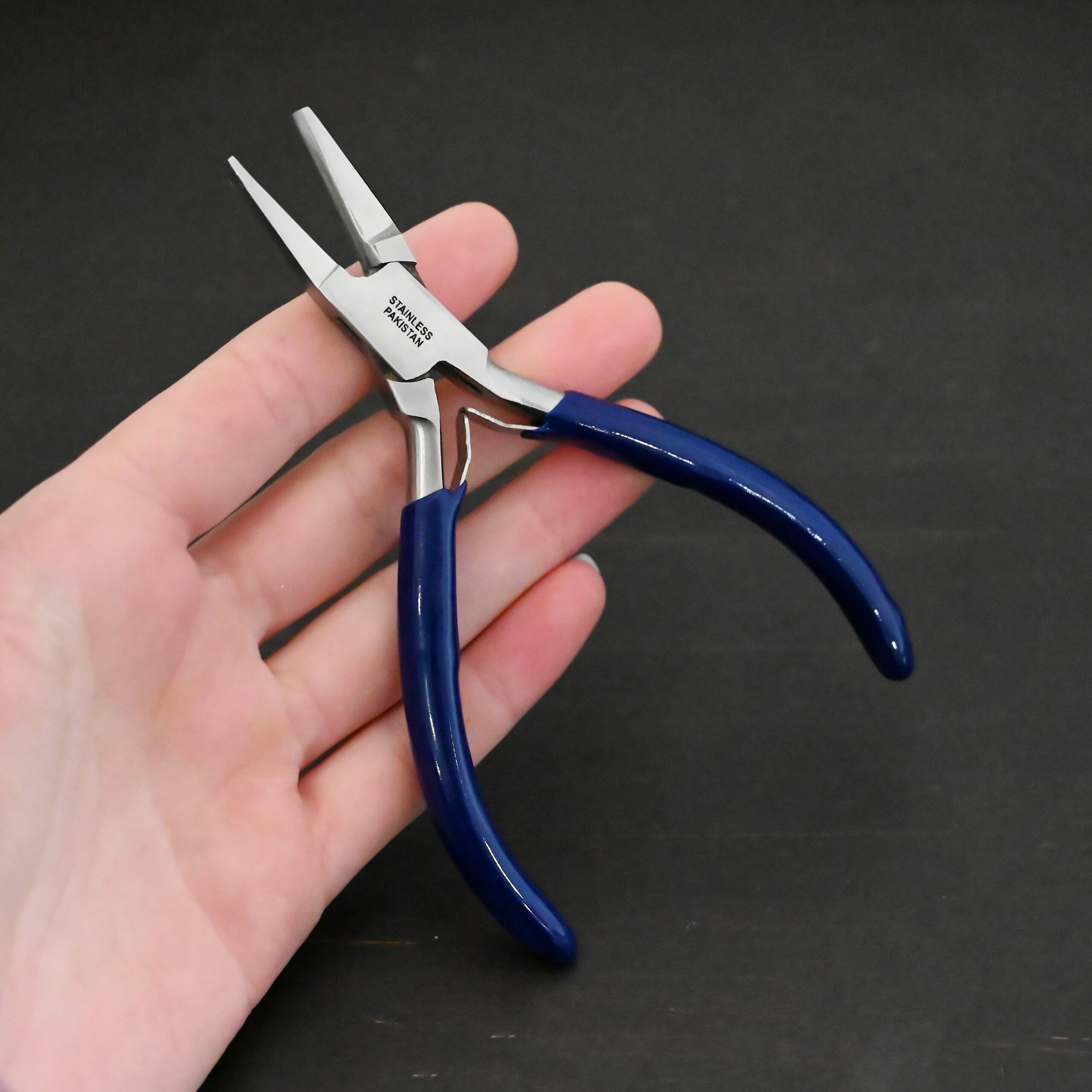 Ring Bending Pliers - Blue rubber handle shown in hand