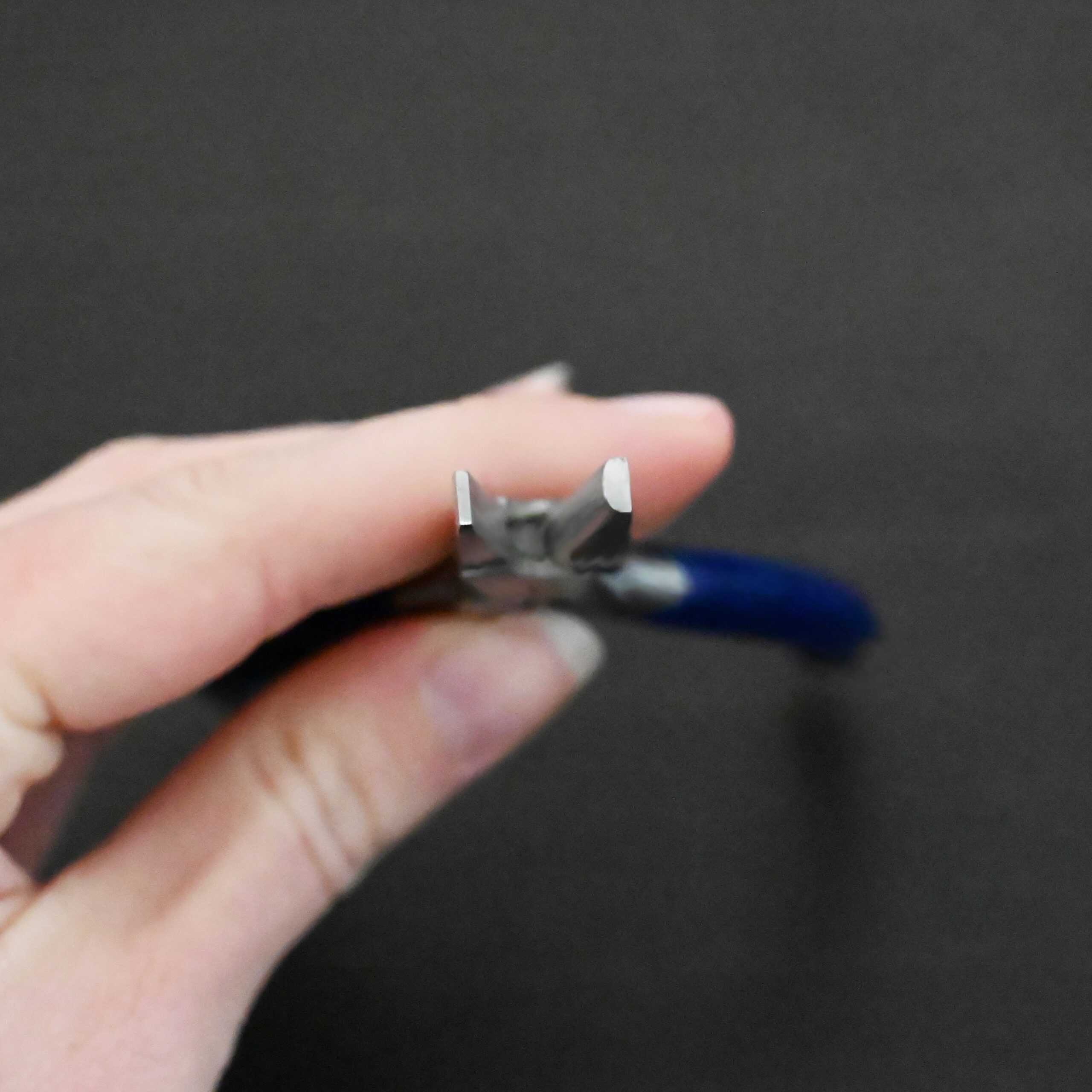 Ring Bending Pliers - Blue rubber handle shown in hand