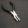 Large stepped mandrel pliers - black rubber handle shown on dark background