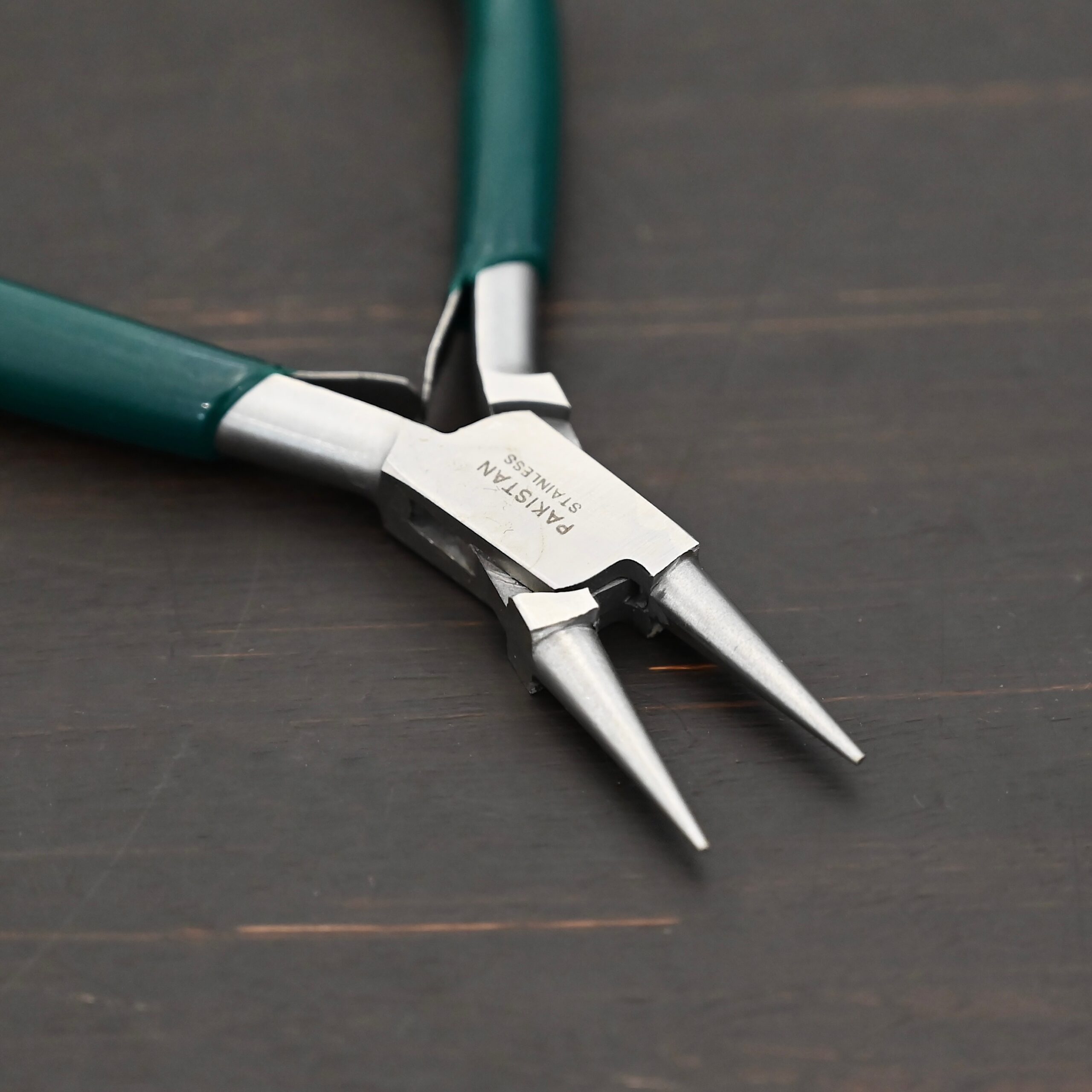 Wire Wrapping pliers - Dark Green rubber handle shown on dark background