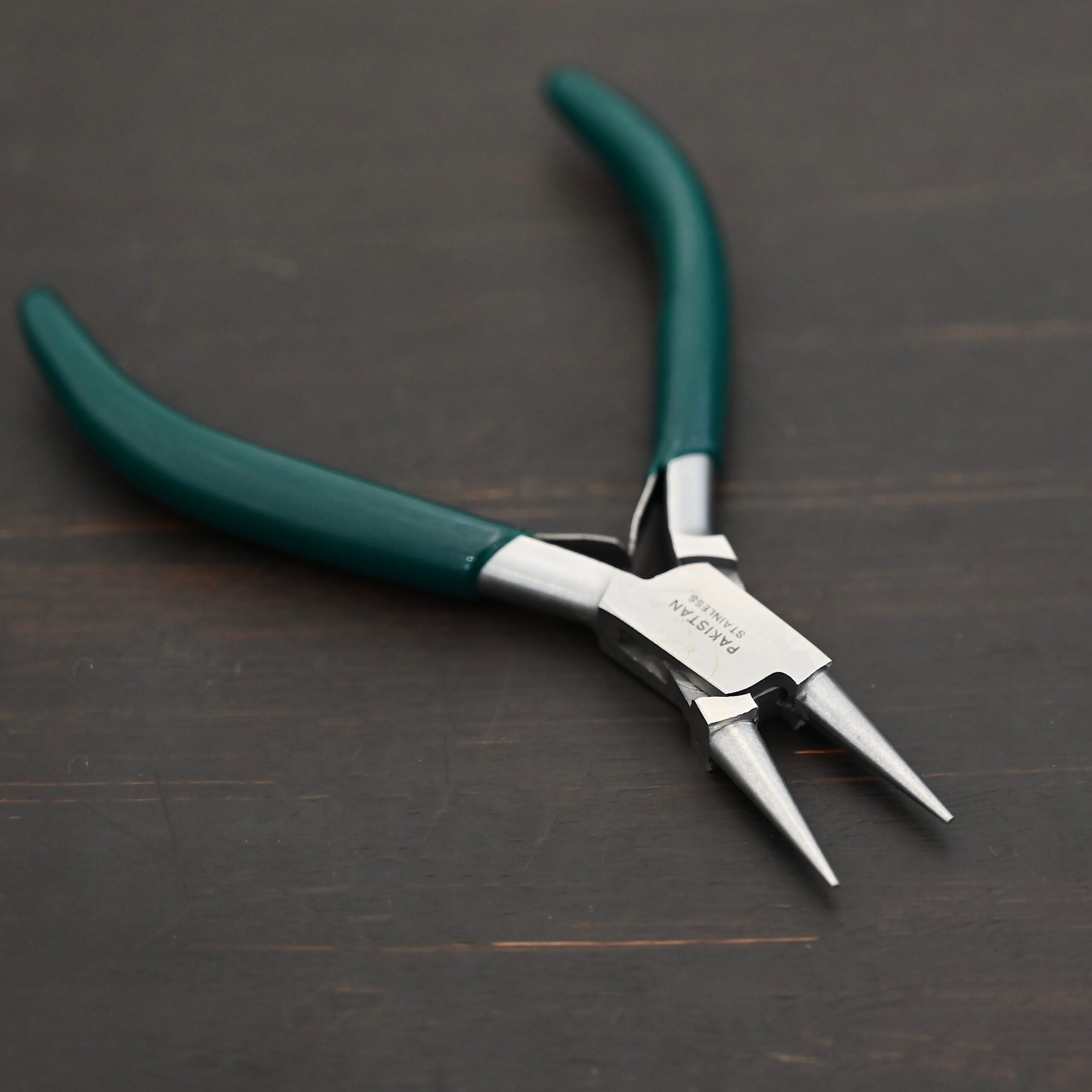 Wire Wrapping pliers - Dark Green rubber handle shown on dark background
