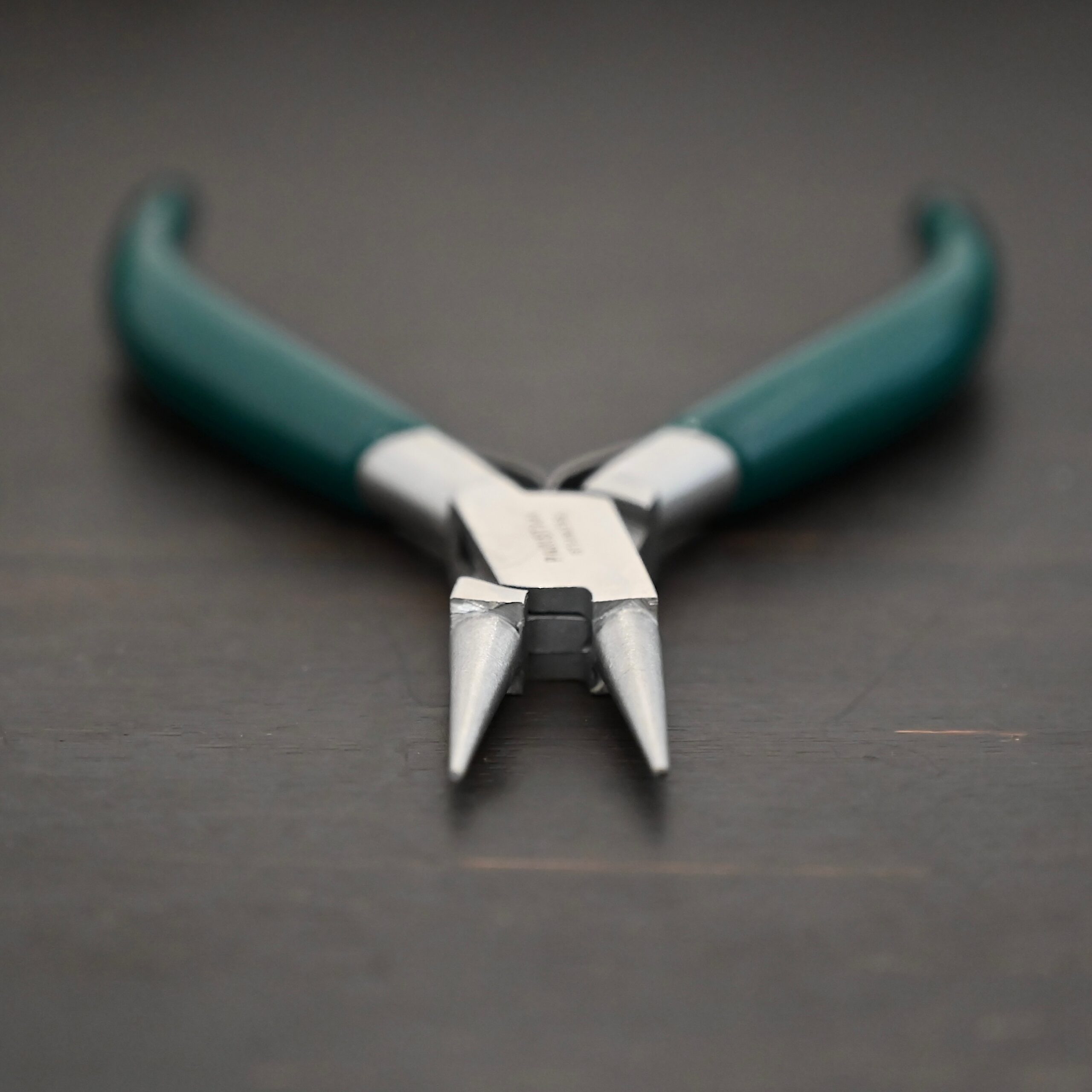 Wire Wrapping pliers - Dark Green rubber handle shown on dark background