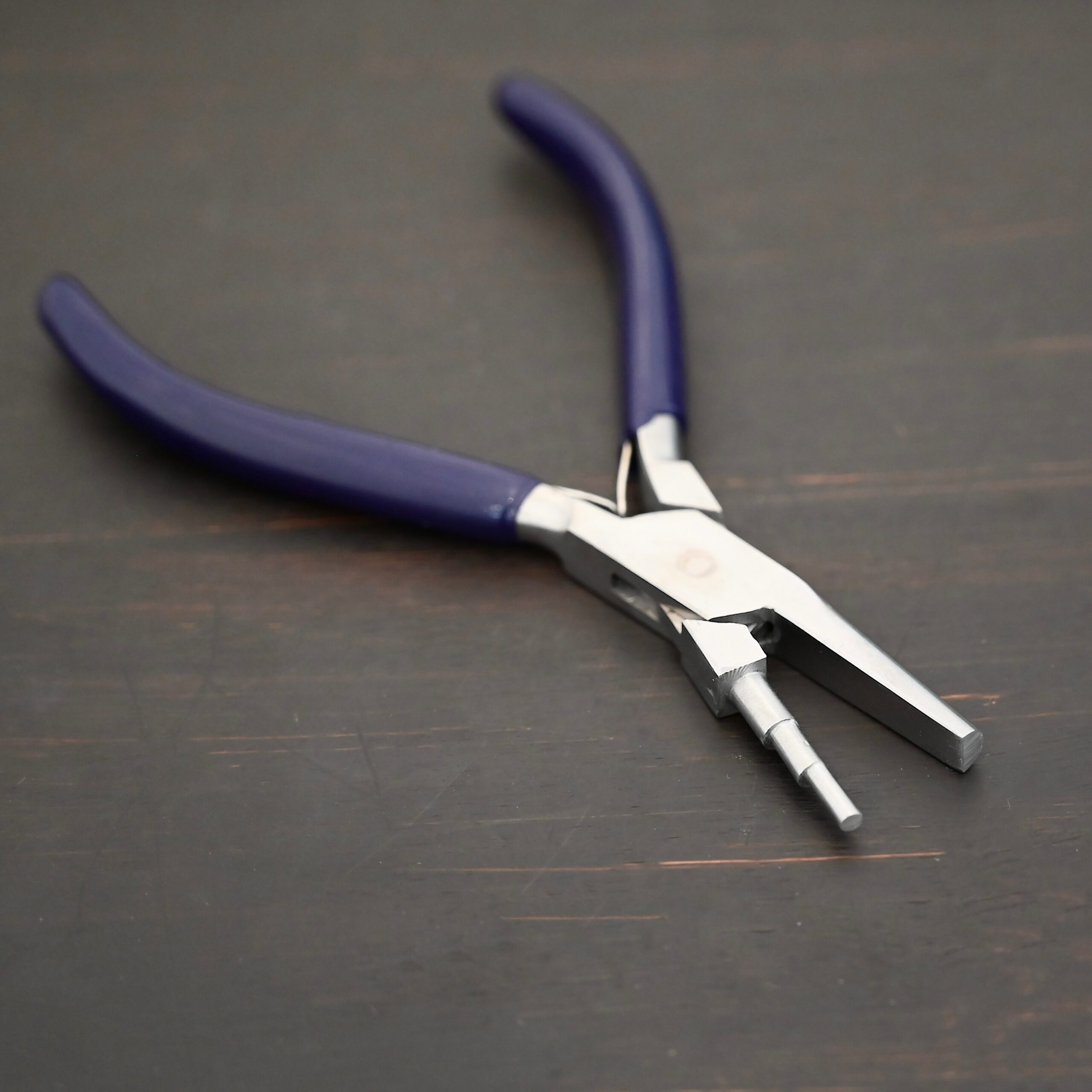 Medium Stepped Mandrel pliers - Dark Blue rubber handle shown on dark background