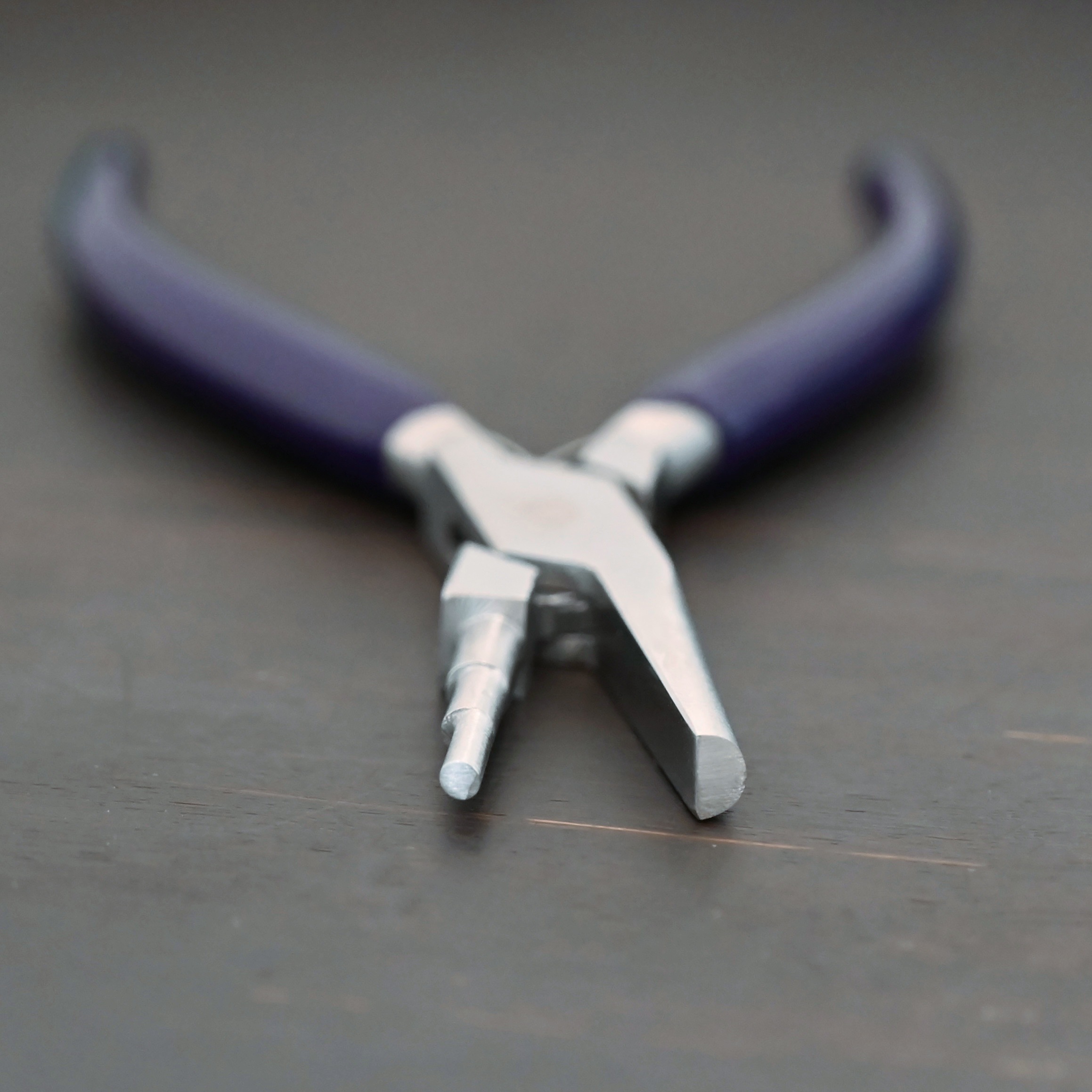 Medium Stepped Mandrel pliers - Dark Blue rubber handle shown on dark background