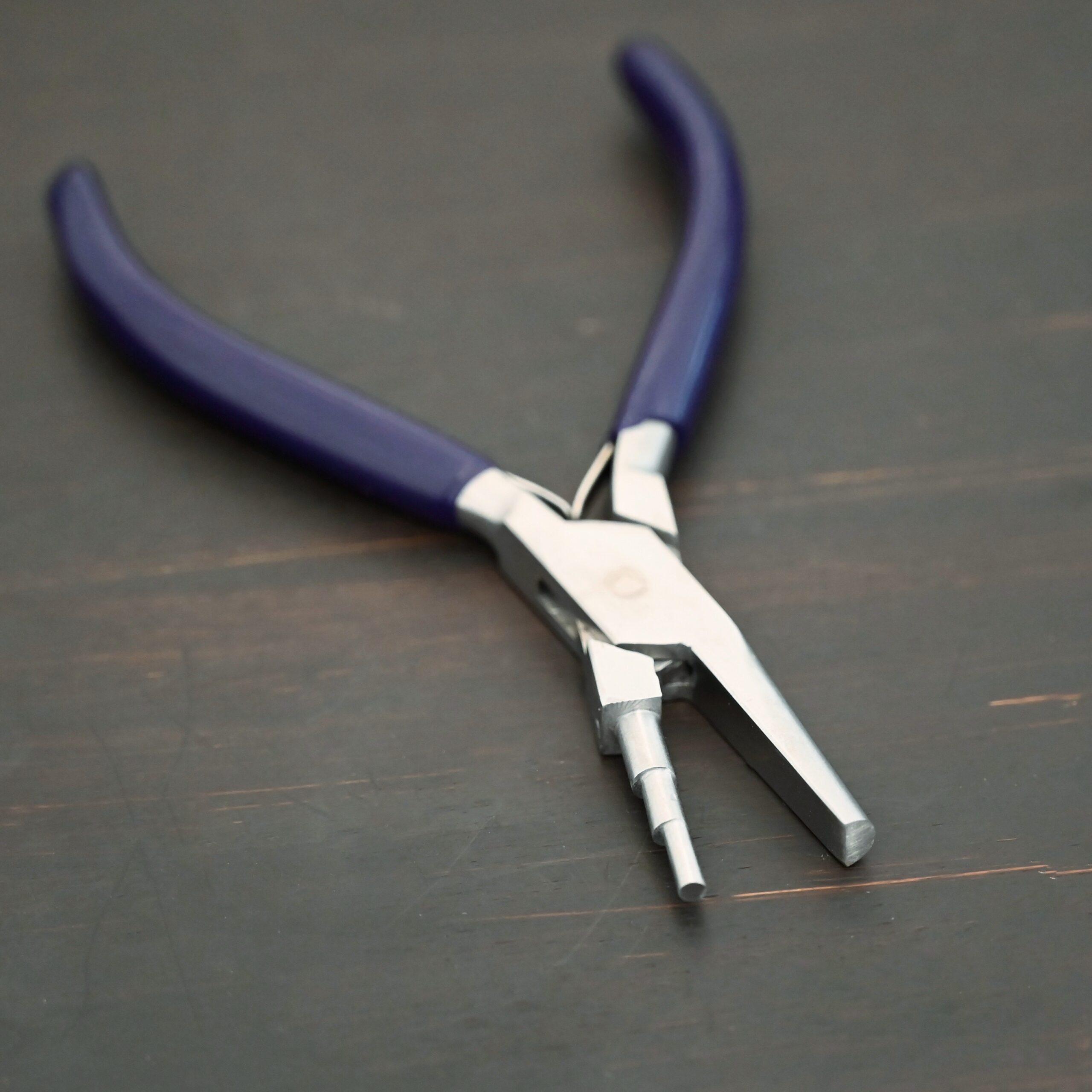 Medium Stepped Mandrel pliers - Dark Blue rubber handle shown on dark background