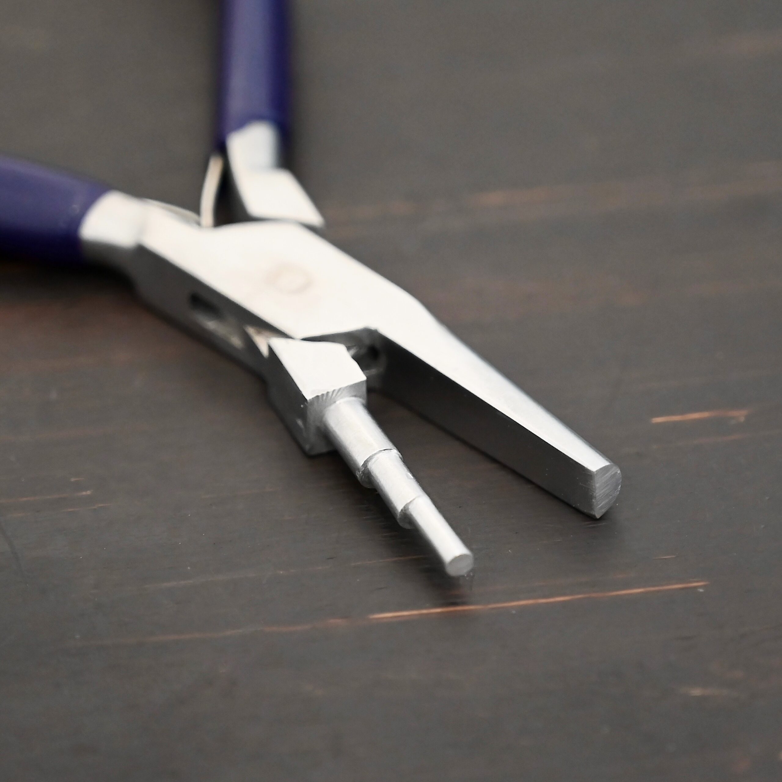 Medium Stepped Mandrel pliers - Dark Blue rubber handle shown on dark background