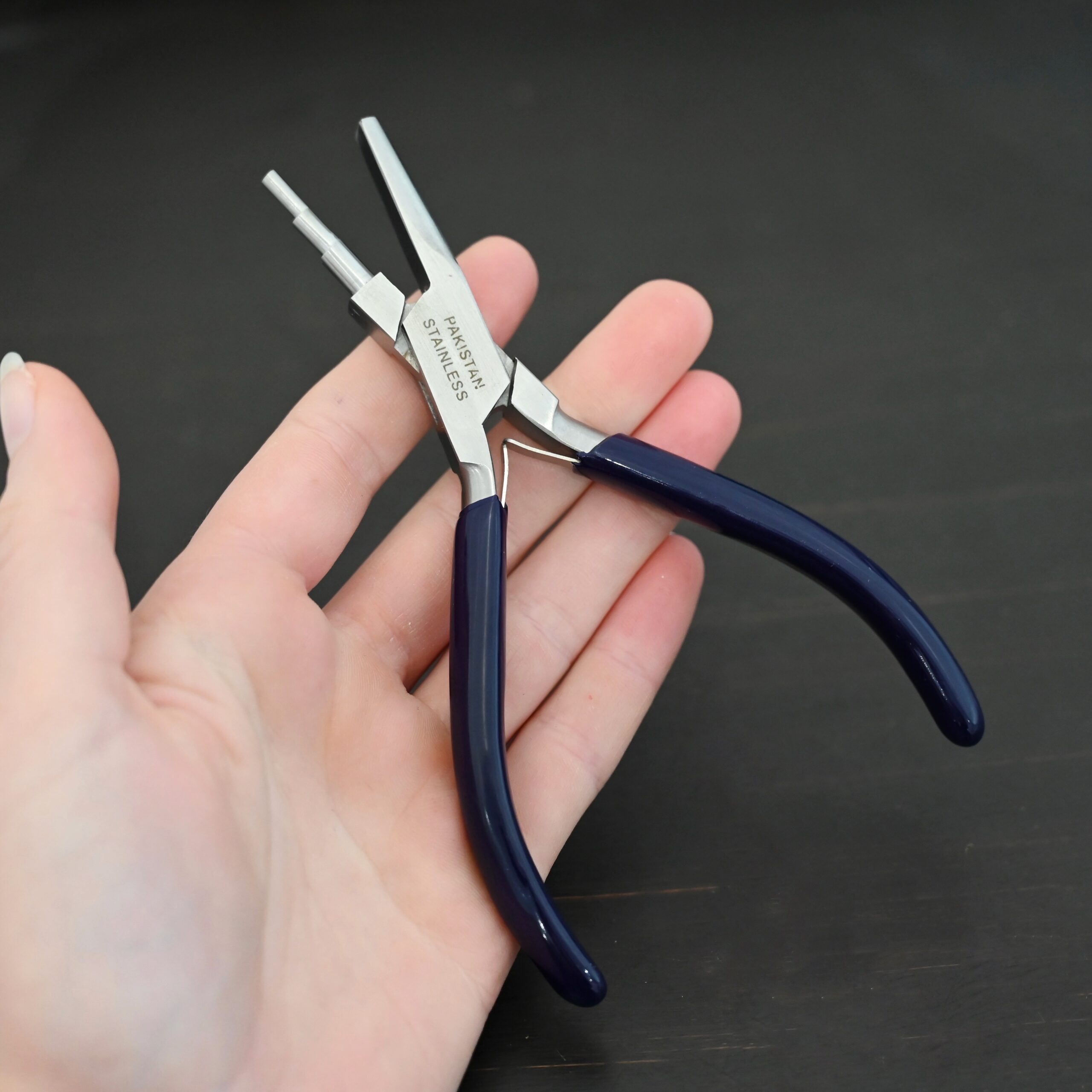 Medium Stepped Mandrel pliers - Dark Blue rubber handle shown in hand