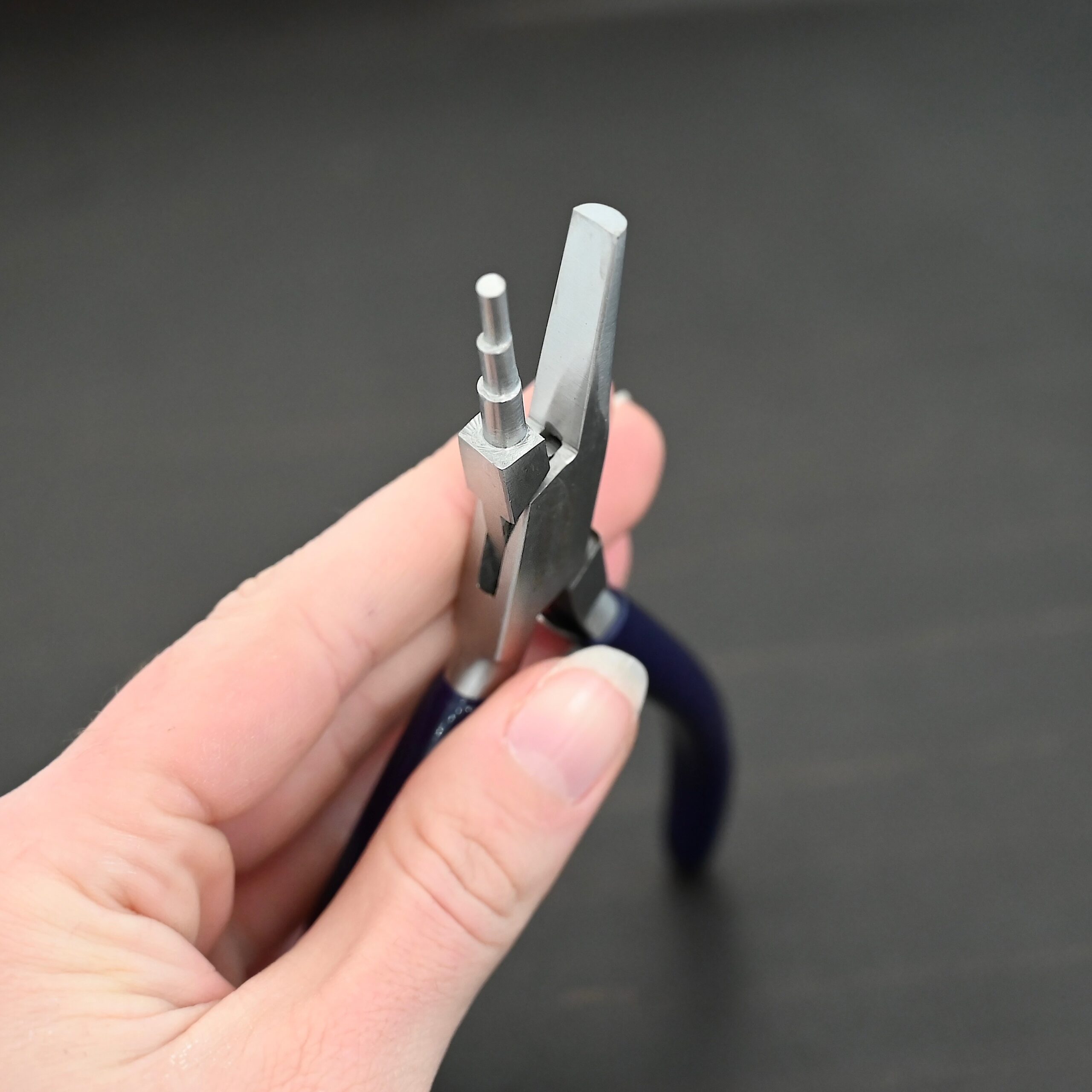 Medium Stepped Mandrel pliers - Dark Blue rubber handle shown in hand