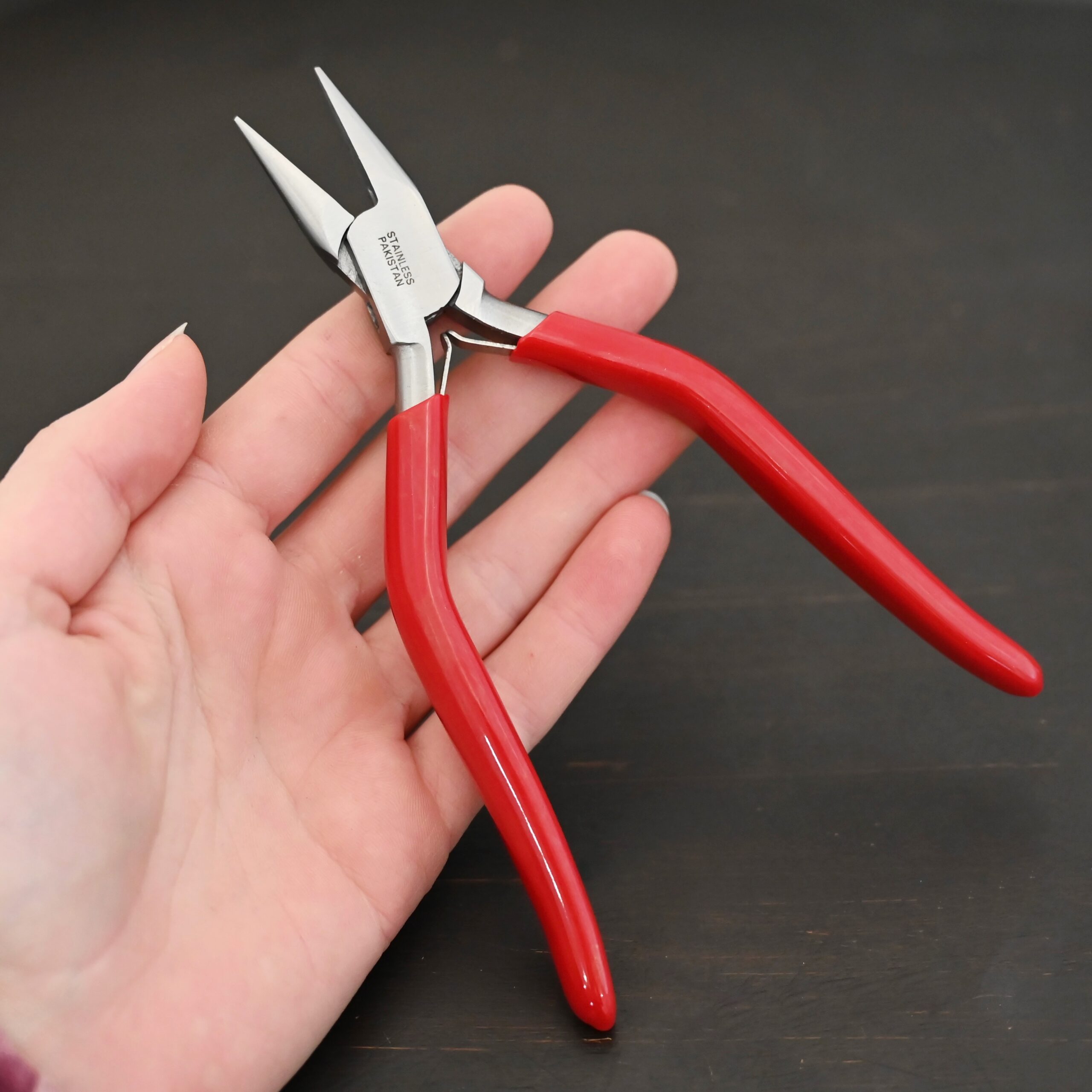 Flat Nosed pliers - Red rubber handle shown in hand