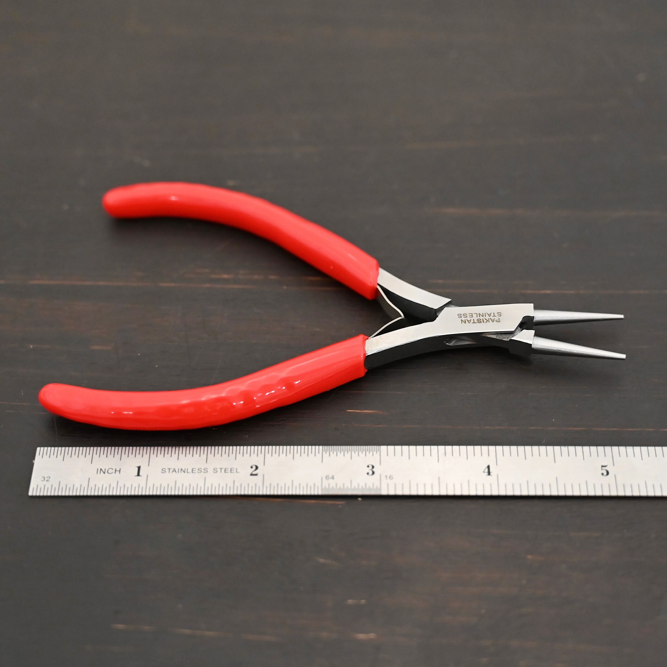 Fine Wire Wrapping pliers - Red rubber handle shown by ruler