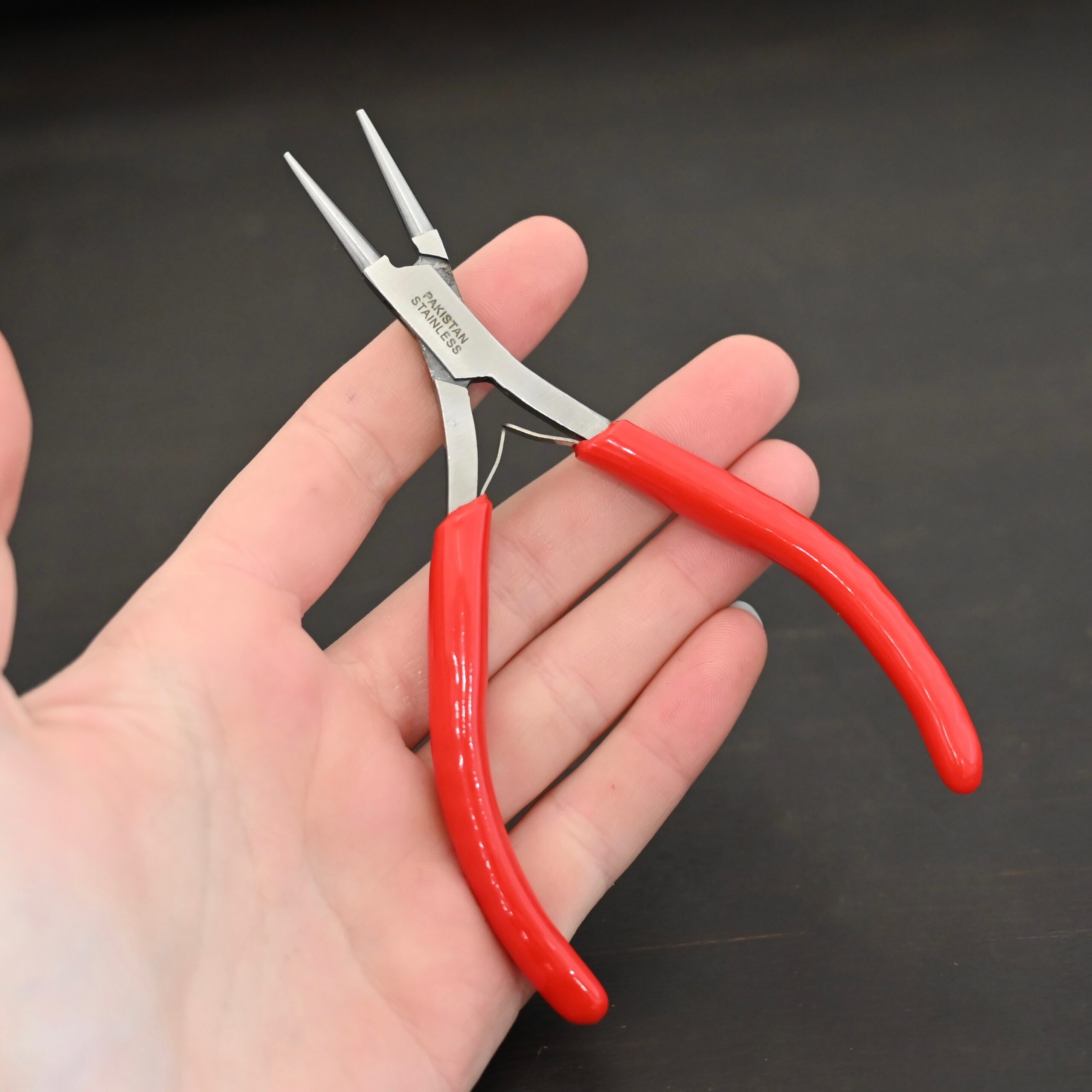Fine Wire Wrapping pliers - Red rubber handle shown in hand