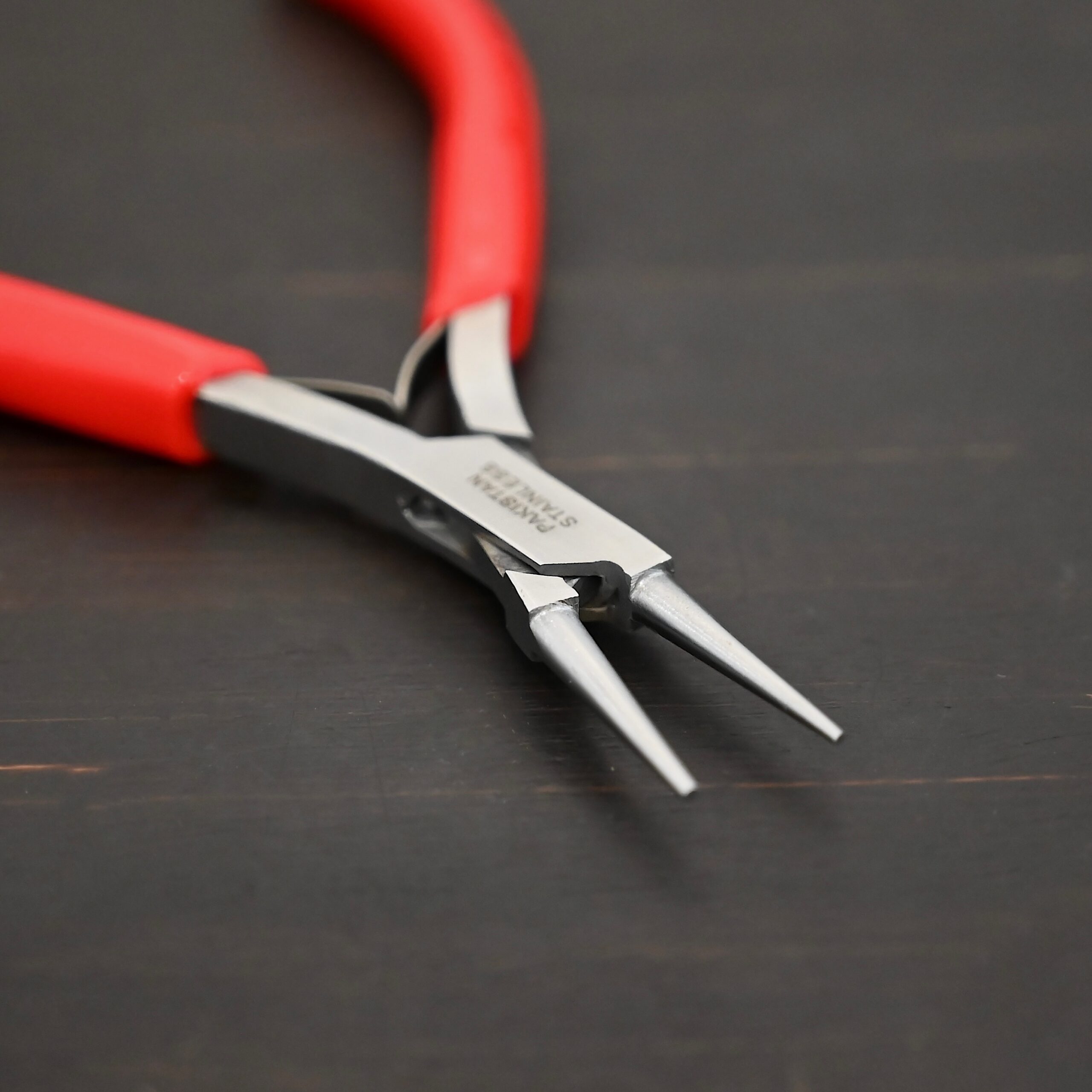Fine Wire Wrapping pliers - Red rubber handle shown on dark background