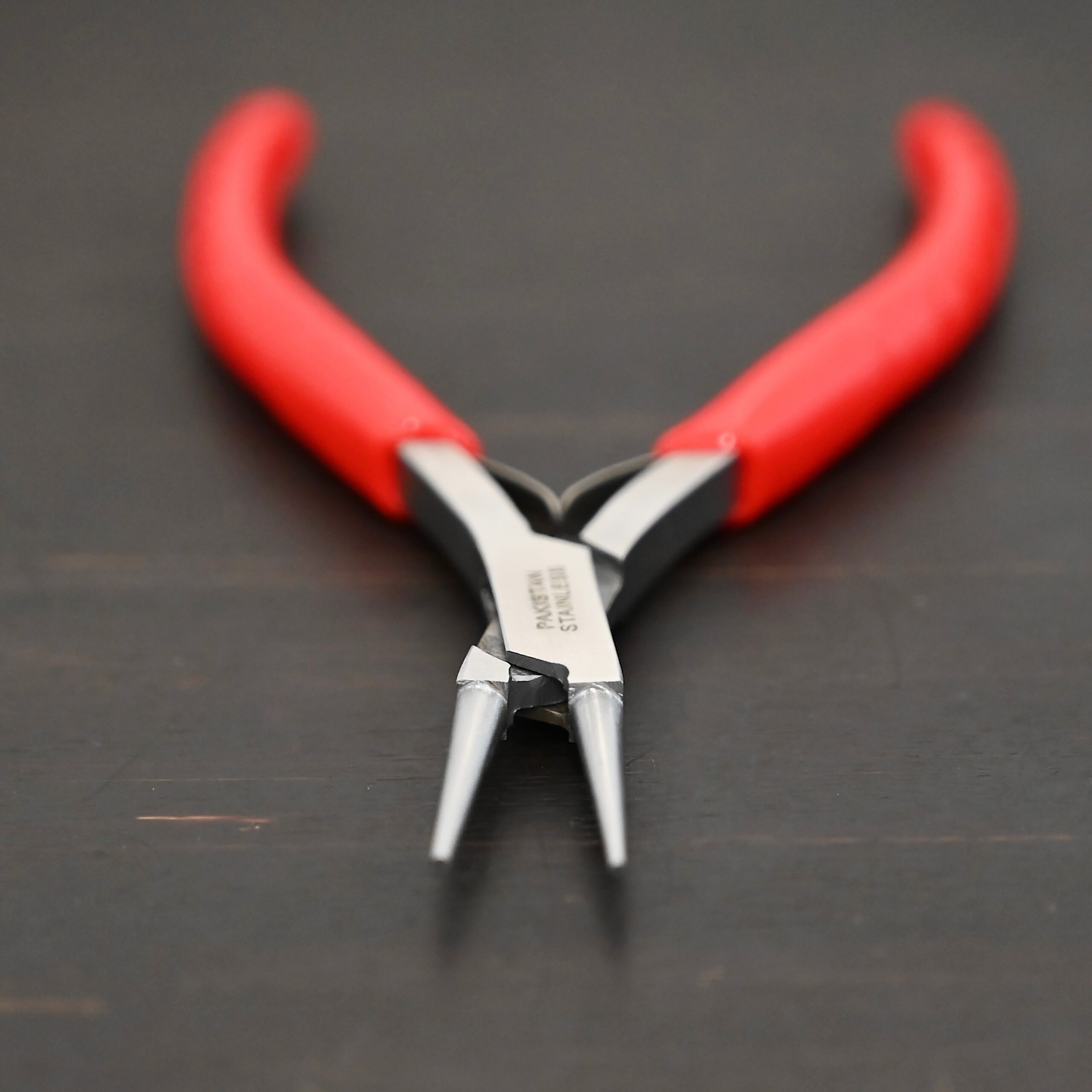 Fine Wire Wrapping pliers - Red rubber handle shown on dark background