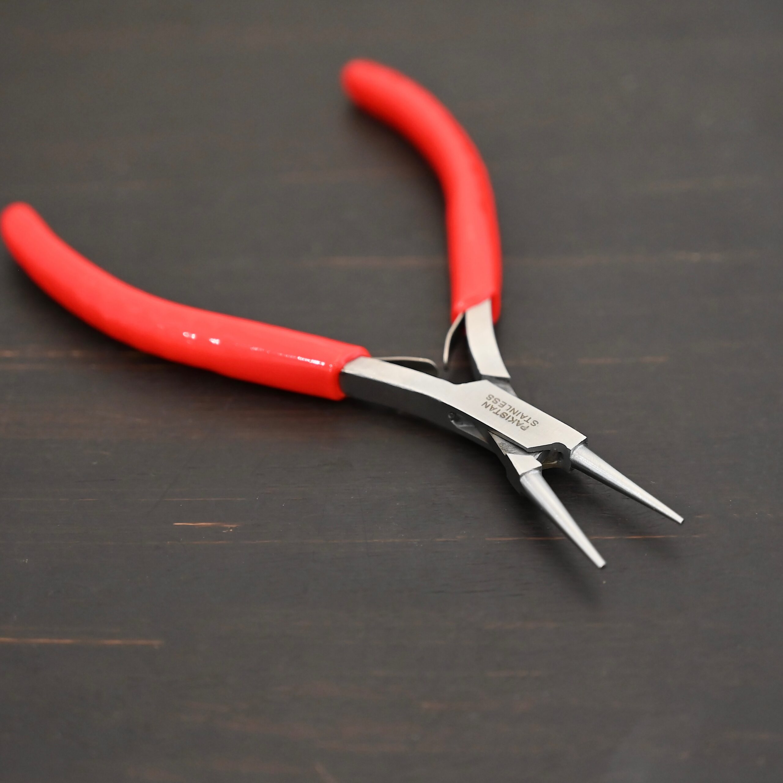 Fine Wire Wrapping pliers - Red rubber handle shown on dark background