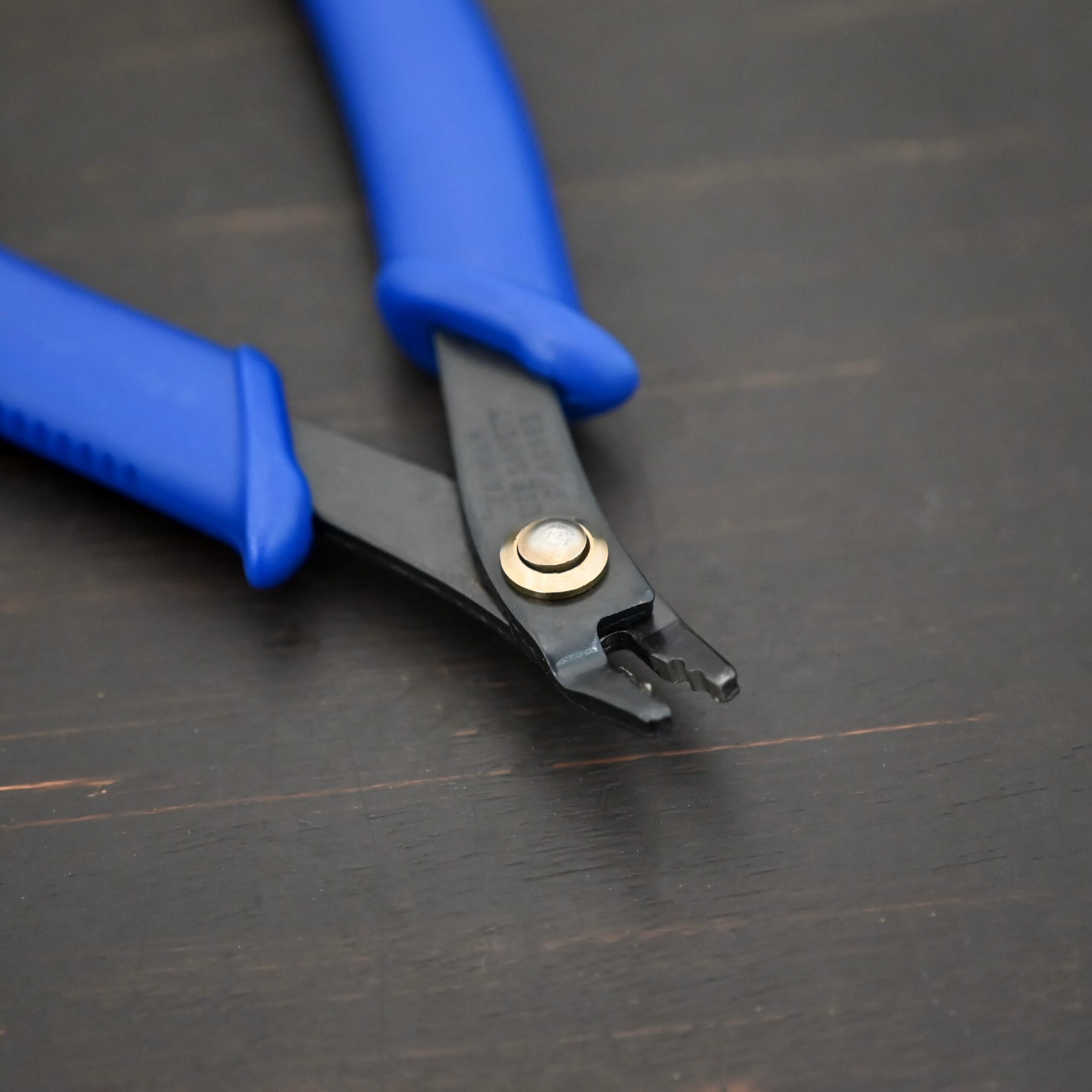 Crimping pliers - Blue Plastic handle shown on dark background