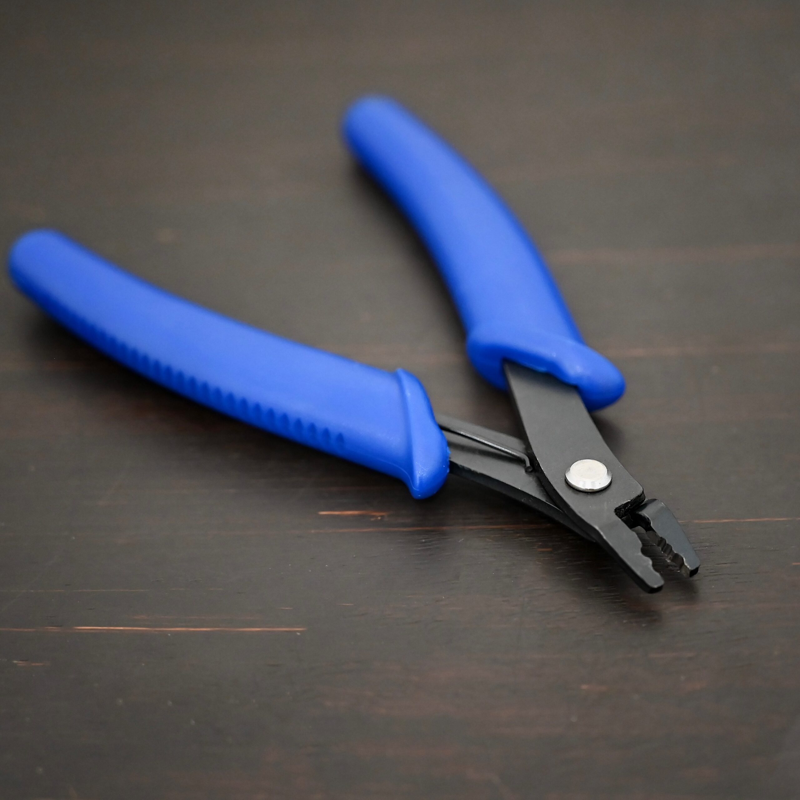 Crimping pliers - Blue Plastic handle shown on dark background