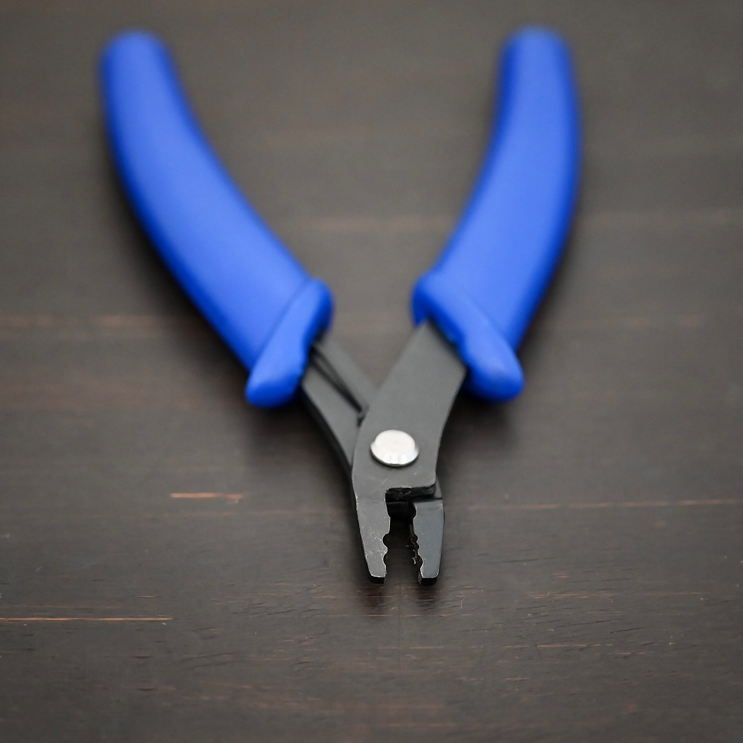 Crimping pliers - Blue Plastic handle shown on dark background