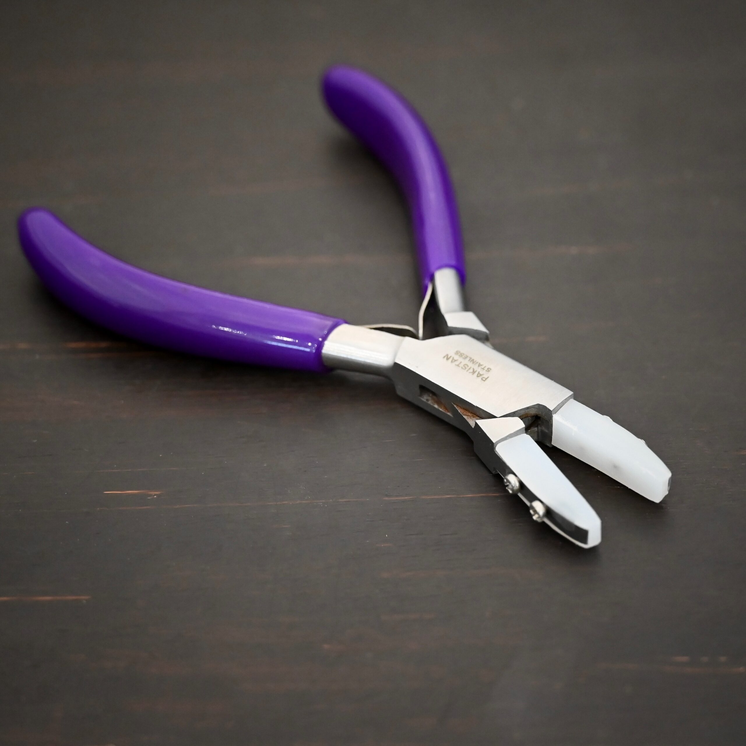 Nylon Jaw Pliers - Purple Rubber handle shown on dark background