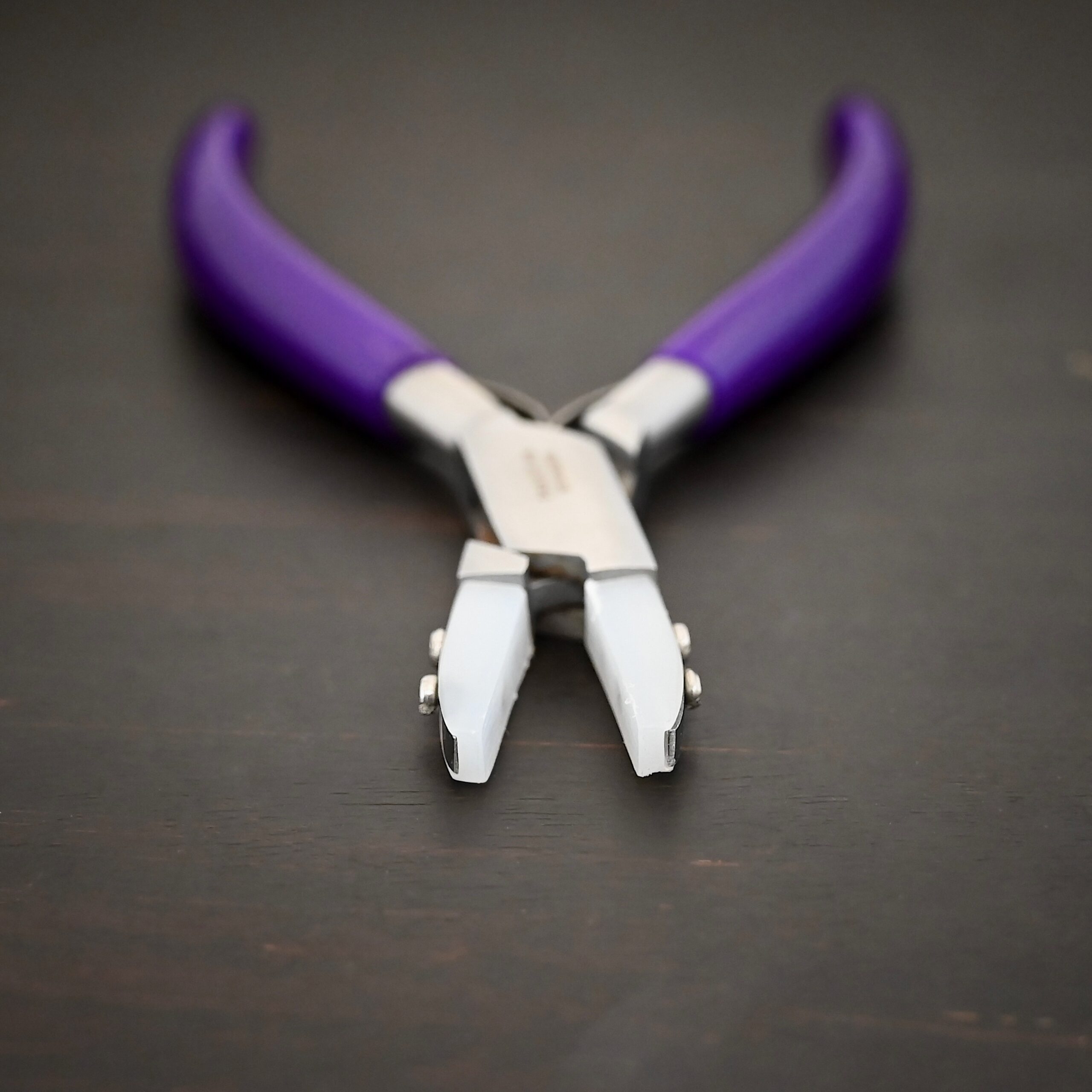 Nylon Jaw Pliers - Purple Rubber handle shown on dark background