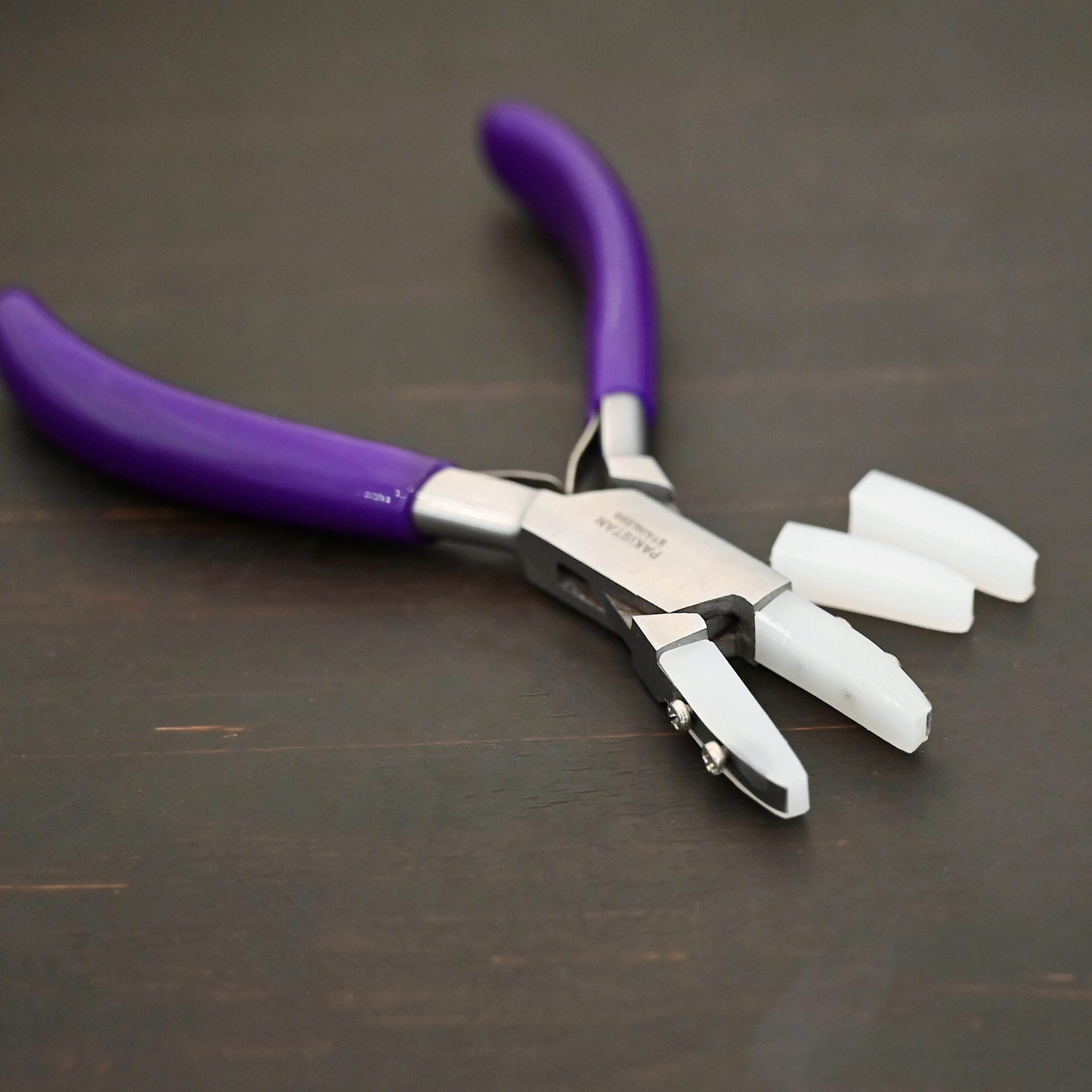 Nylon Jaw Pliers - Purple Rubber handle shown on dark background