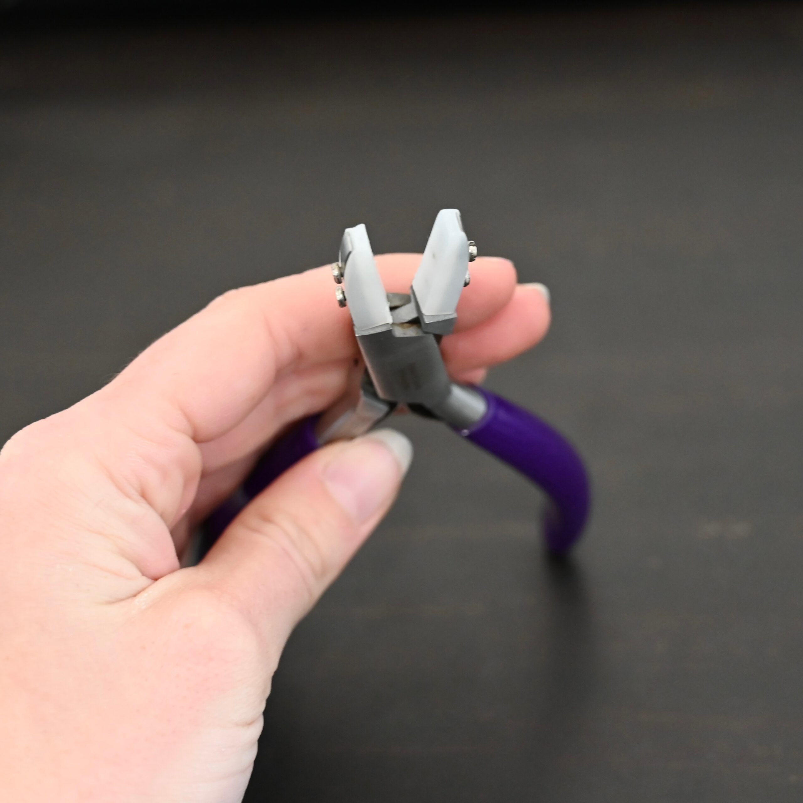 Nylon Jaw Pliers - Purple Rubber handle shown in hand