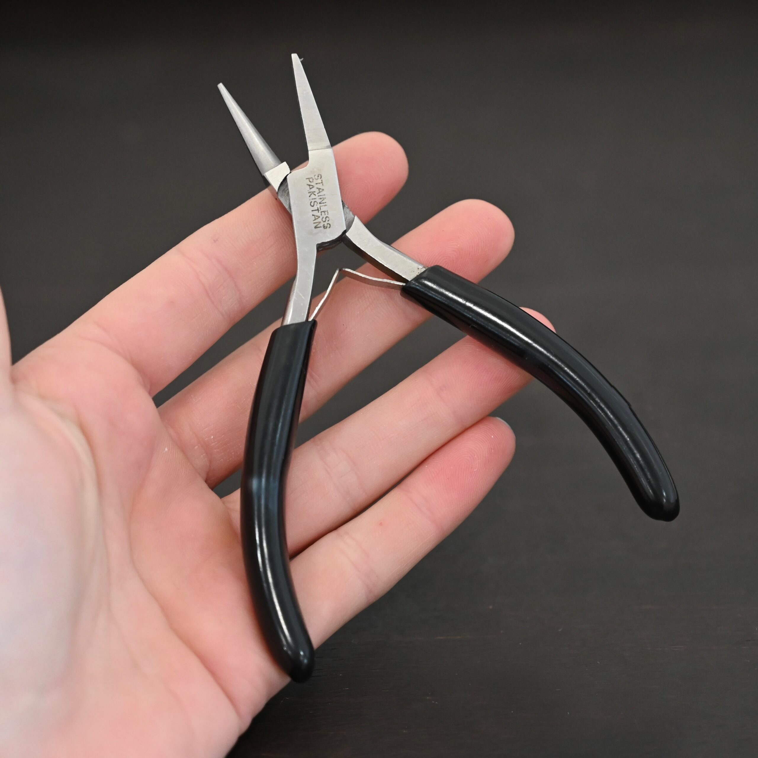 Round/Flat Nosed Pliers - Black Rubber handle shown on in hand