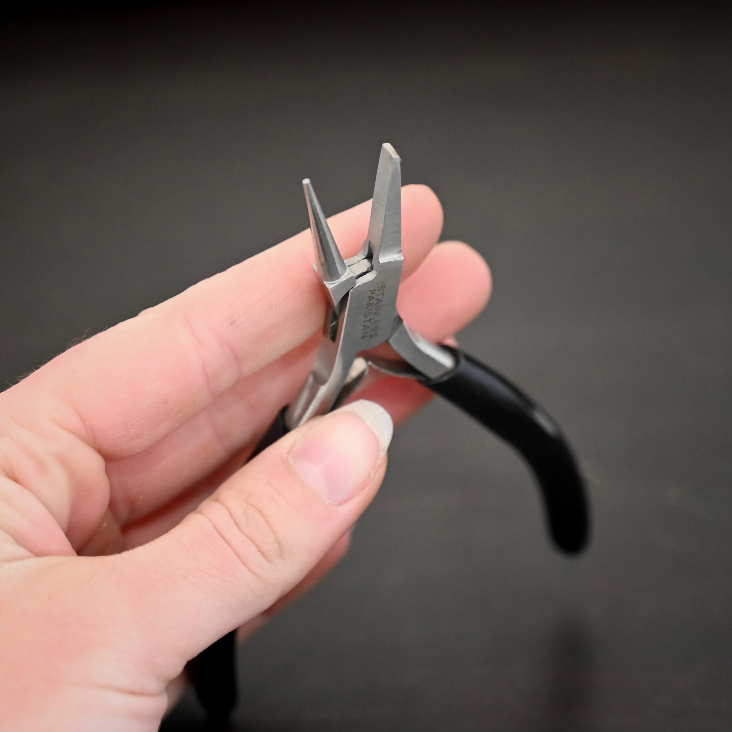 Round/Flat Nosed Pliers - Black Rubber handle shown on in hand