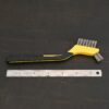 Stainless Steel Wire Brush - black and yellow plastic handle shown next to ruler