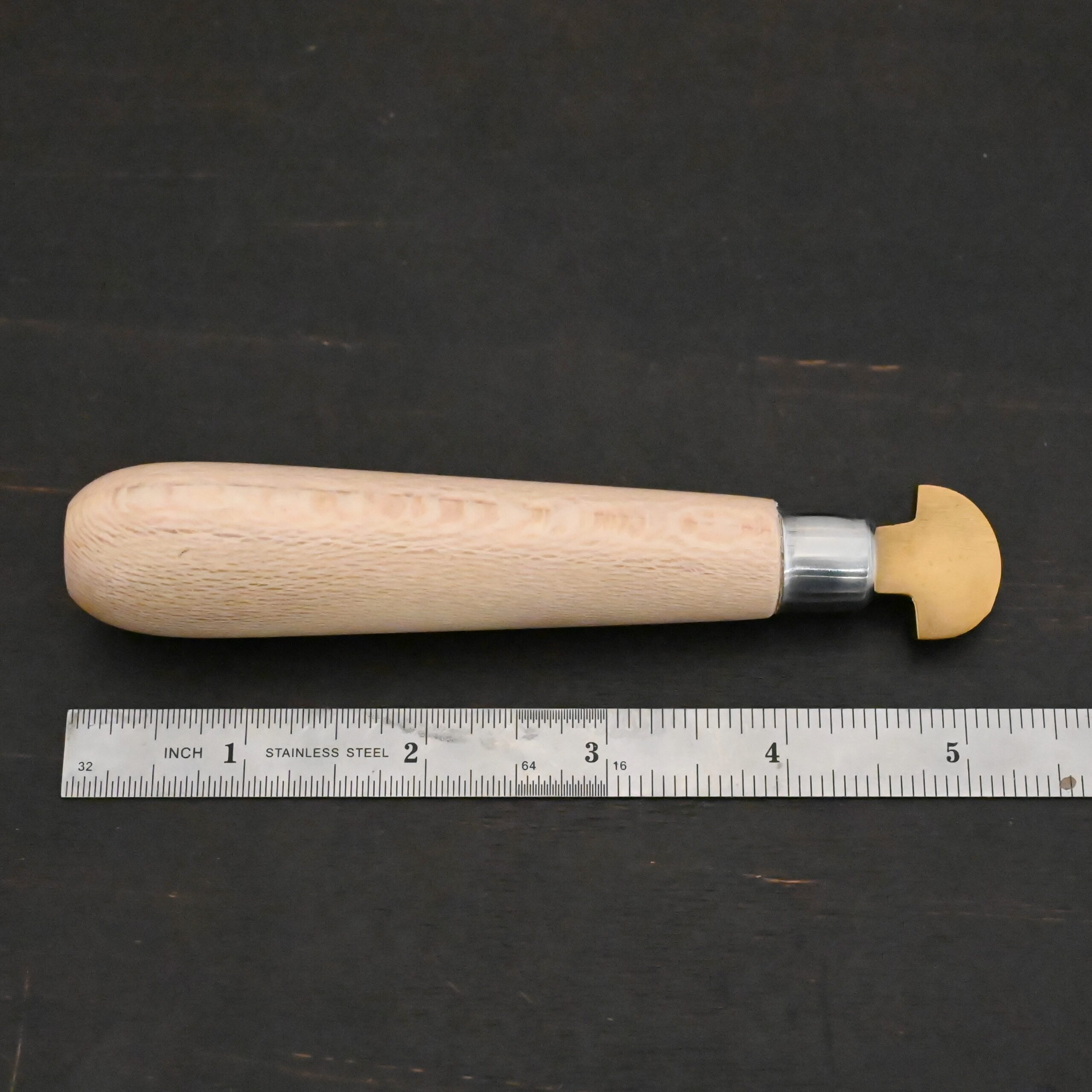 Brass Bezel Roller wooden handle shown on by ruler