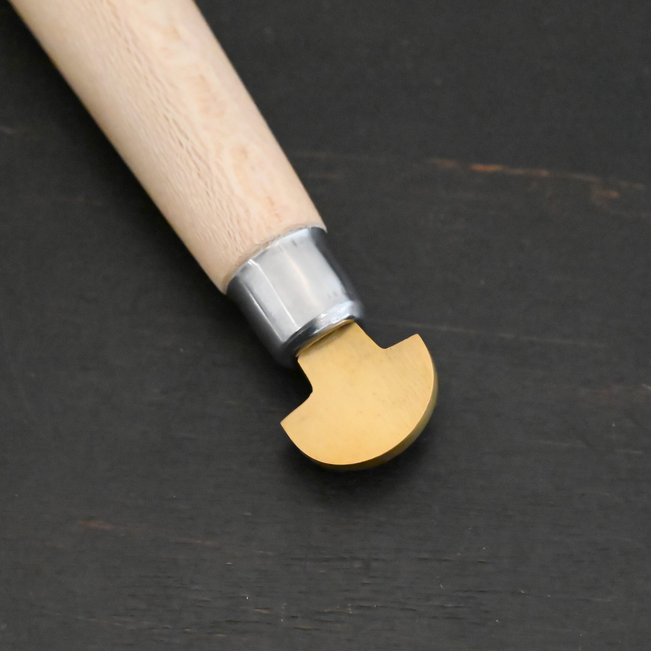 Brass Bezel Roller wooden handle shown on dark background