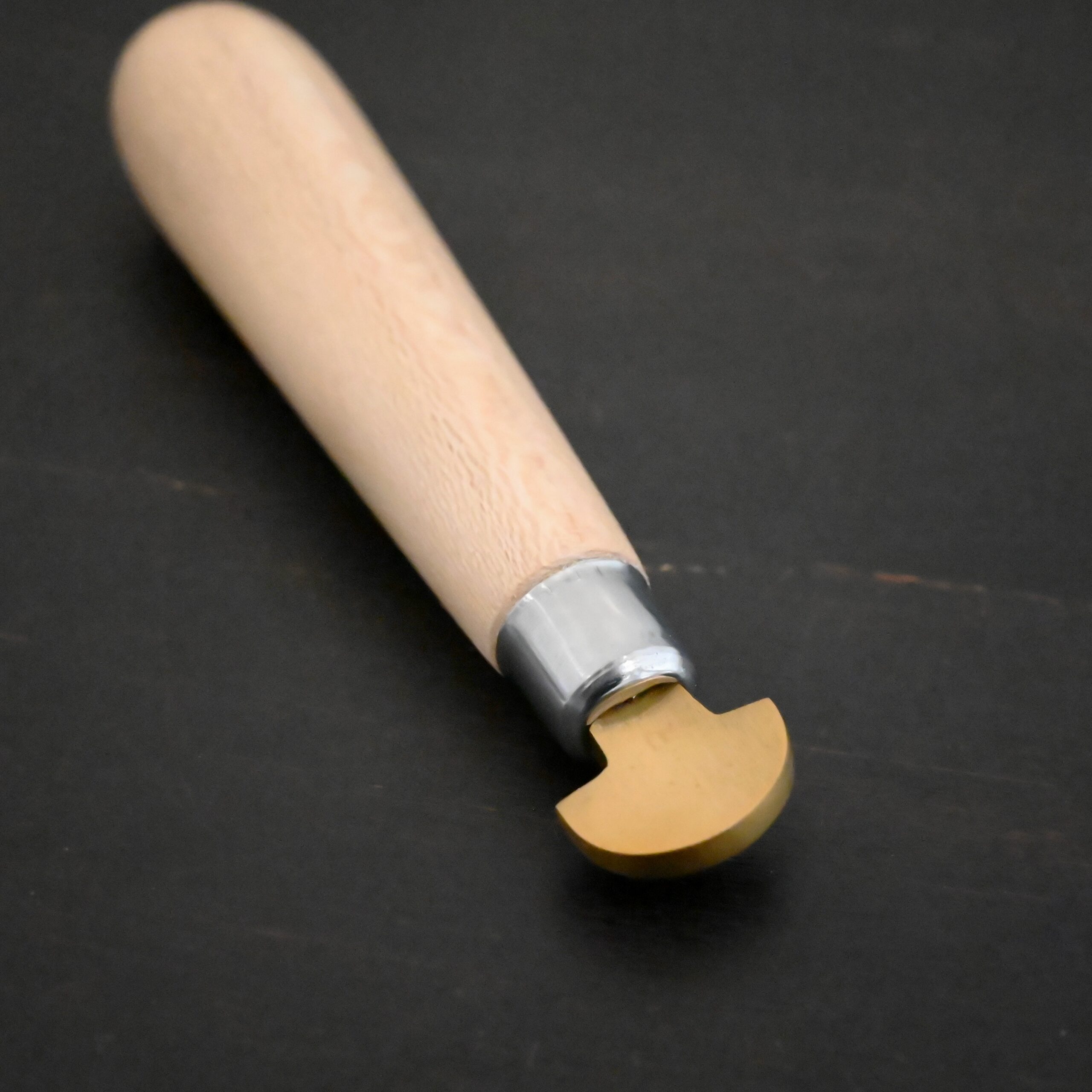 Brass Bezel Roller wooden handle shown on dark background