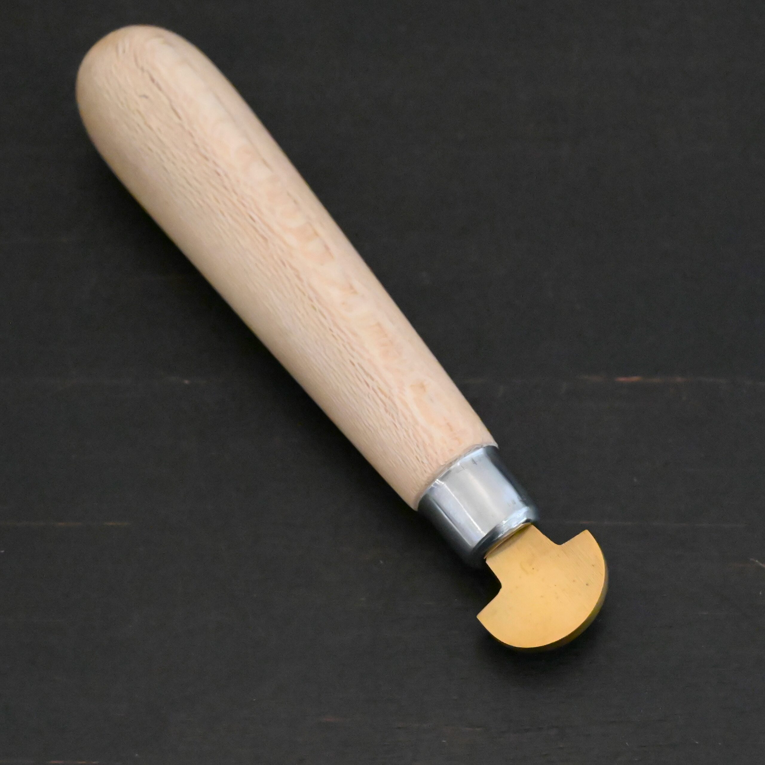 Brass Bezel Roller wooden handle shown on dark background