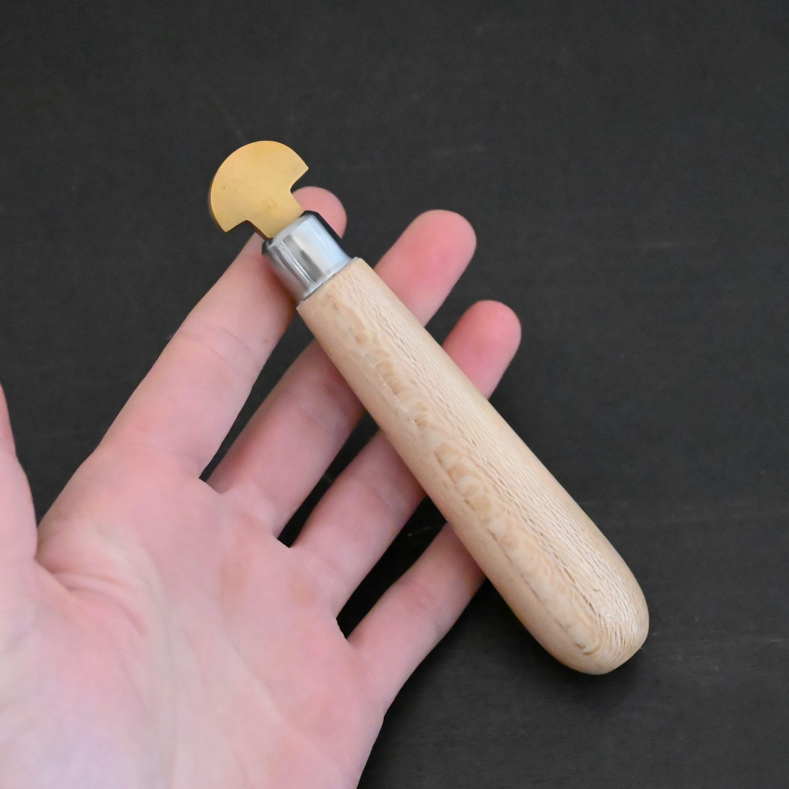 Brass Bezel Roller wooden handle shown in hand