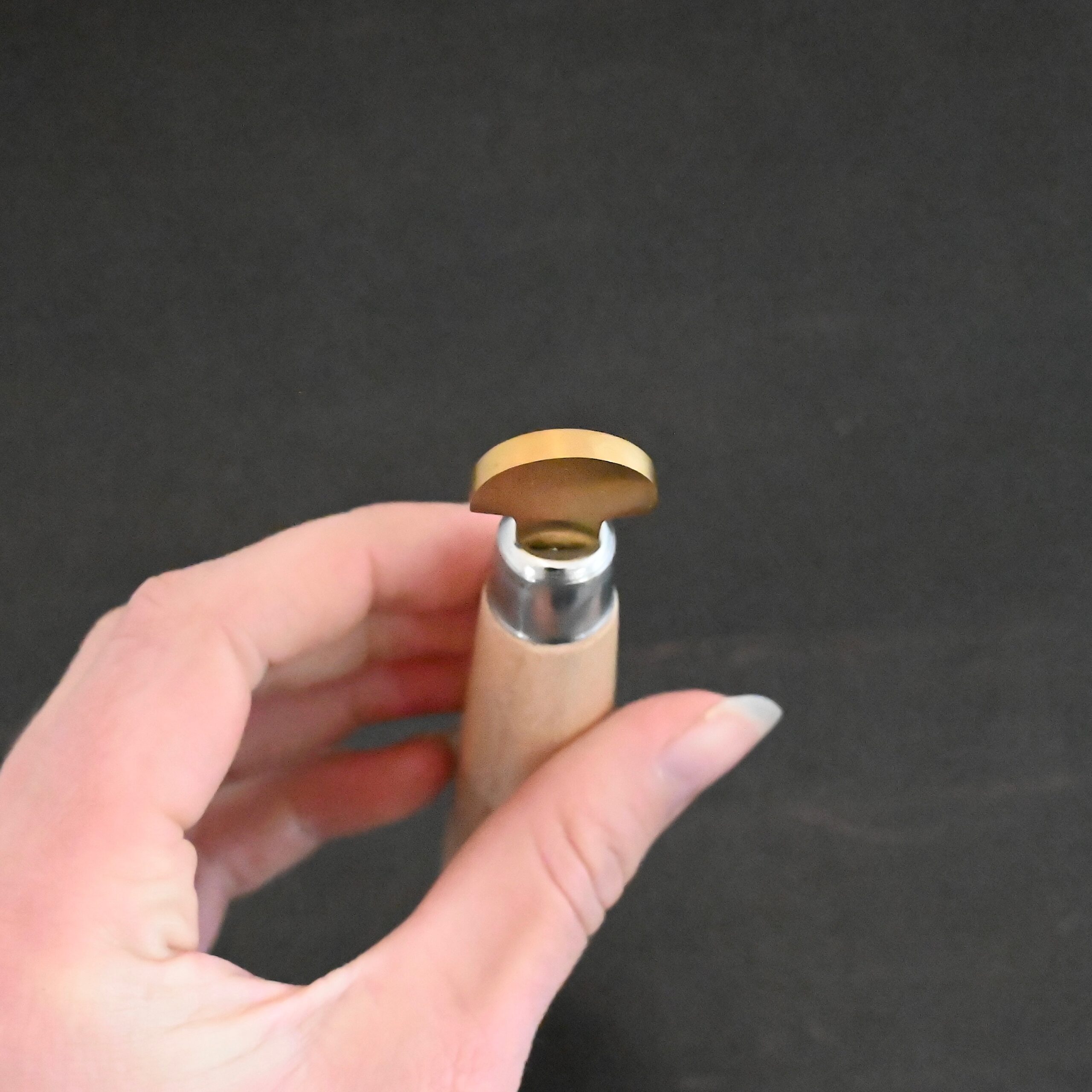 Brass Bezel Roller wooden handle shown in hand