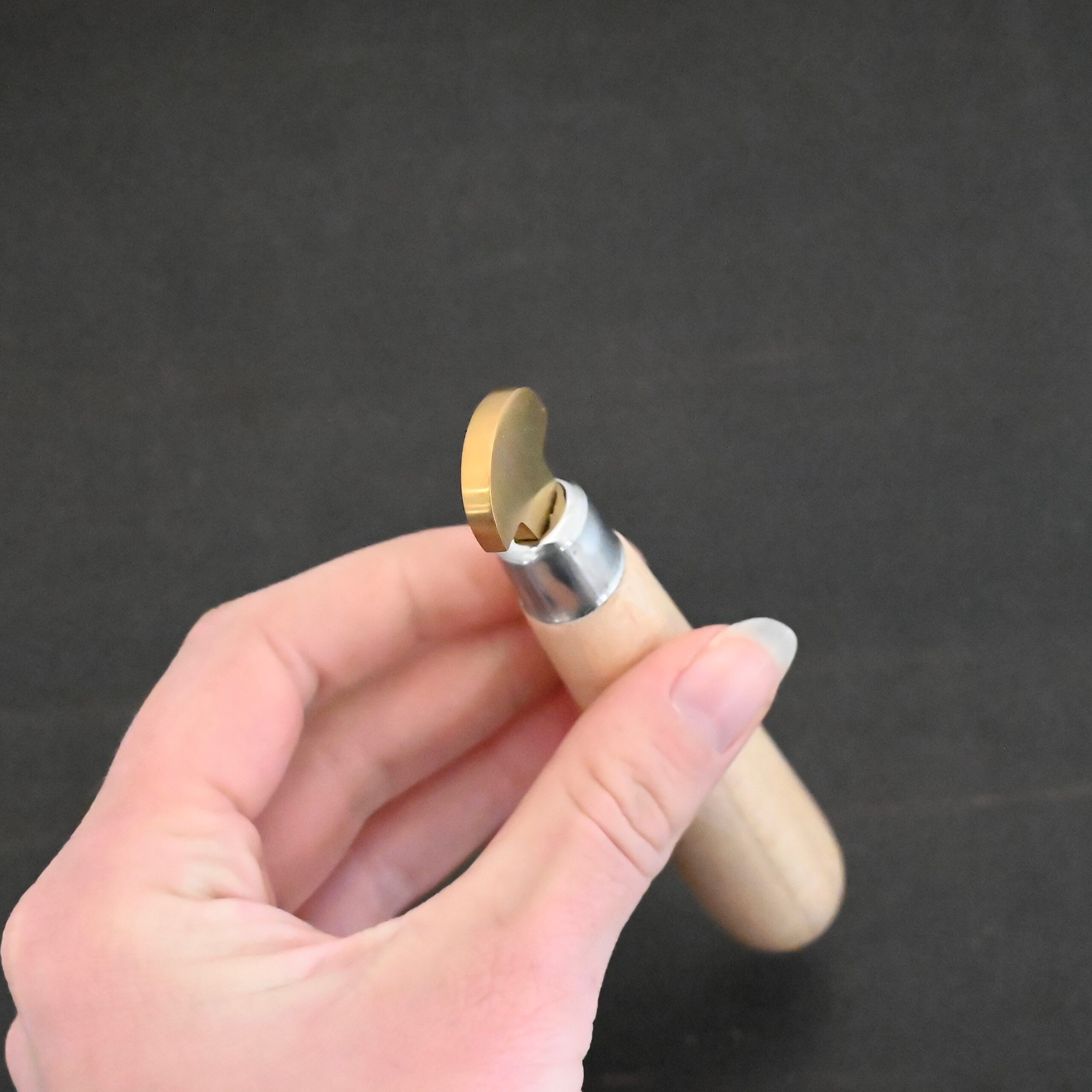 Brass Bezel Roller wooden handle shown in hand