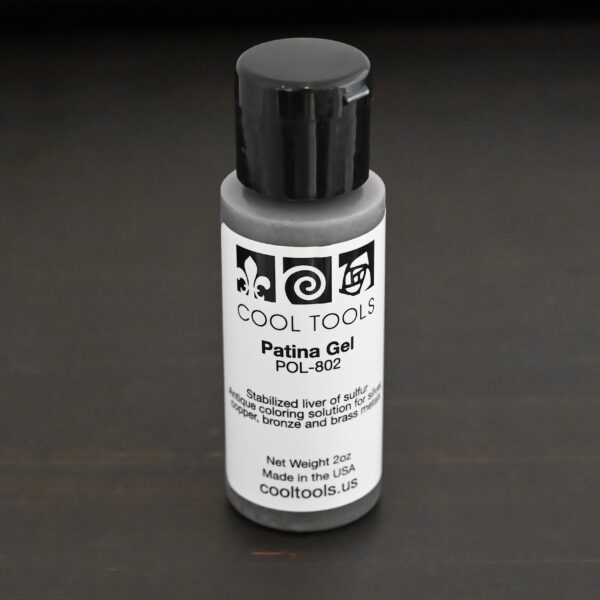 Gel Patina 2oz bottle with black top shown on dar background