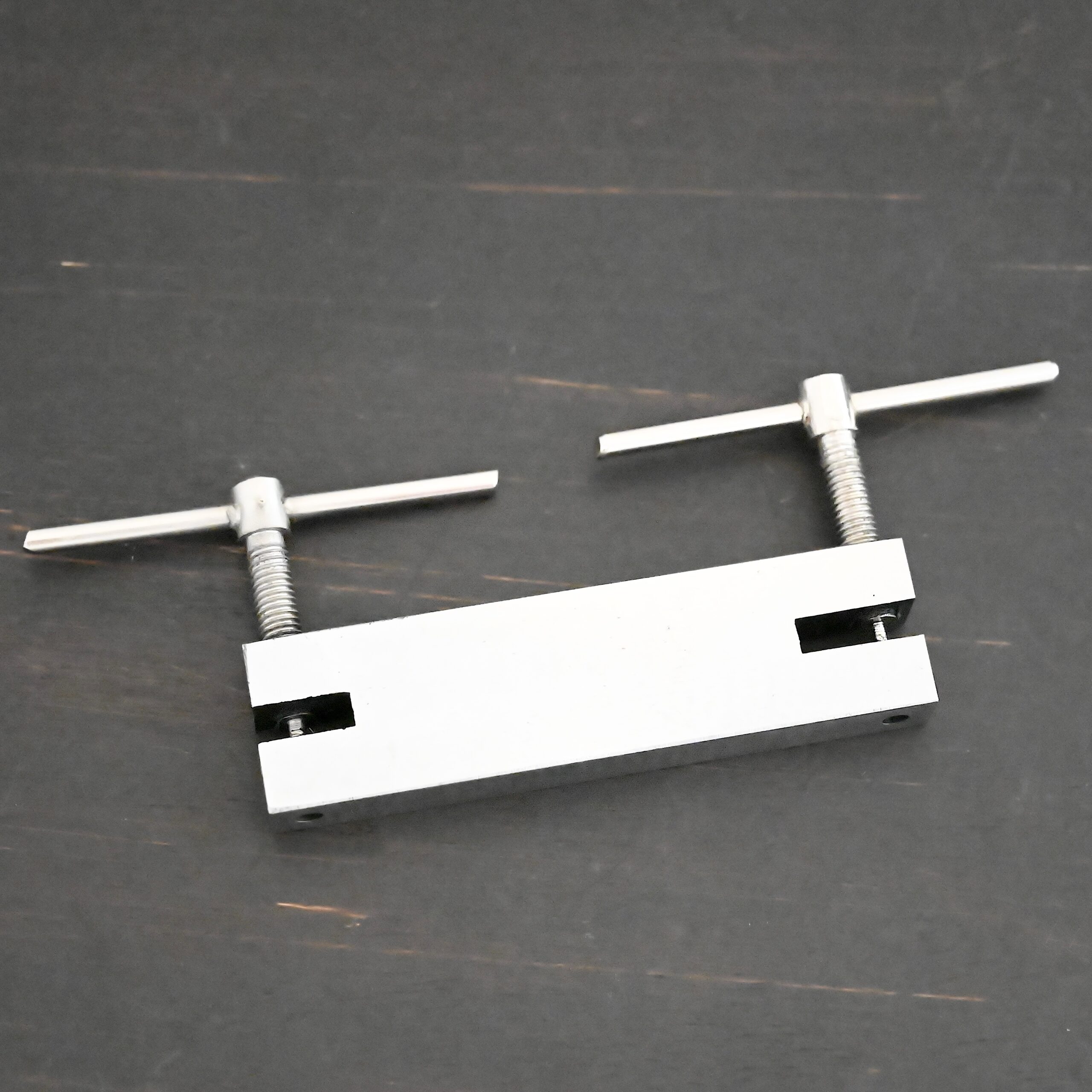 Stainless Steel Hole Punch & Twist Tool shown on dark background