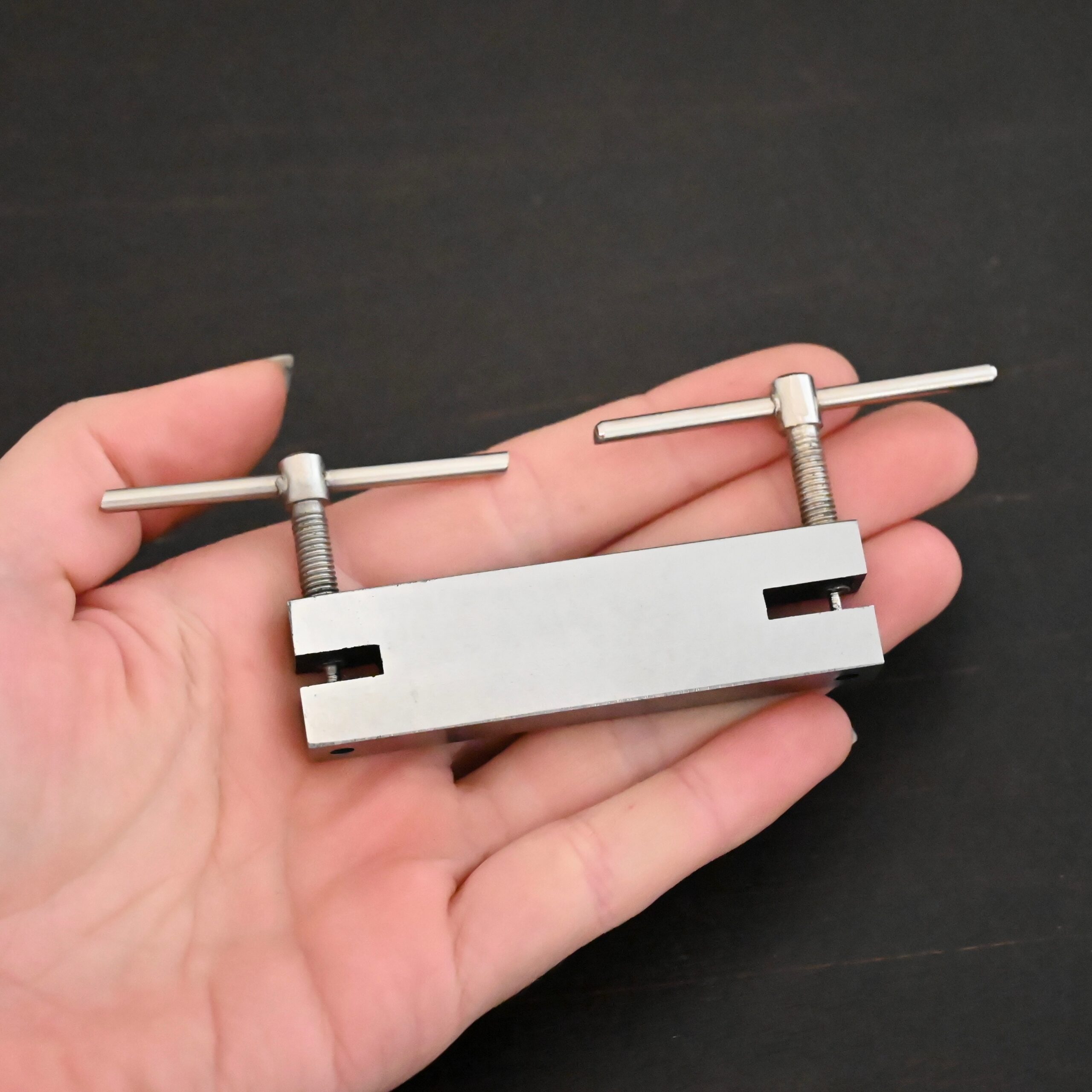 Stainless Steel Hole Punch & Twist Tool shown in hand