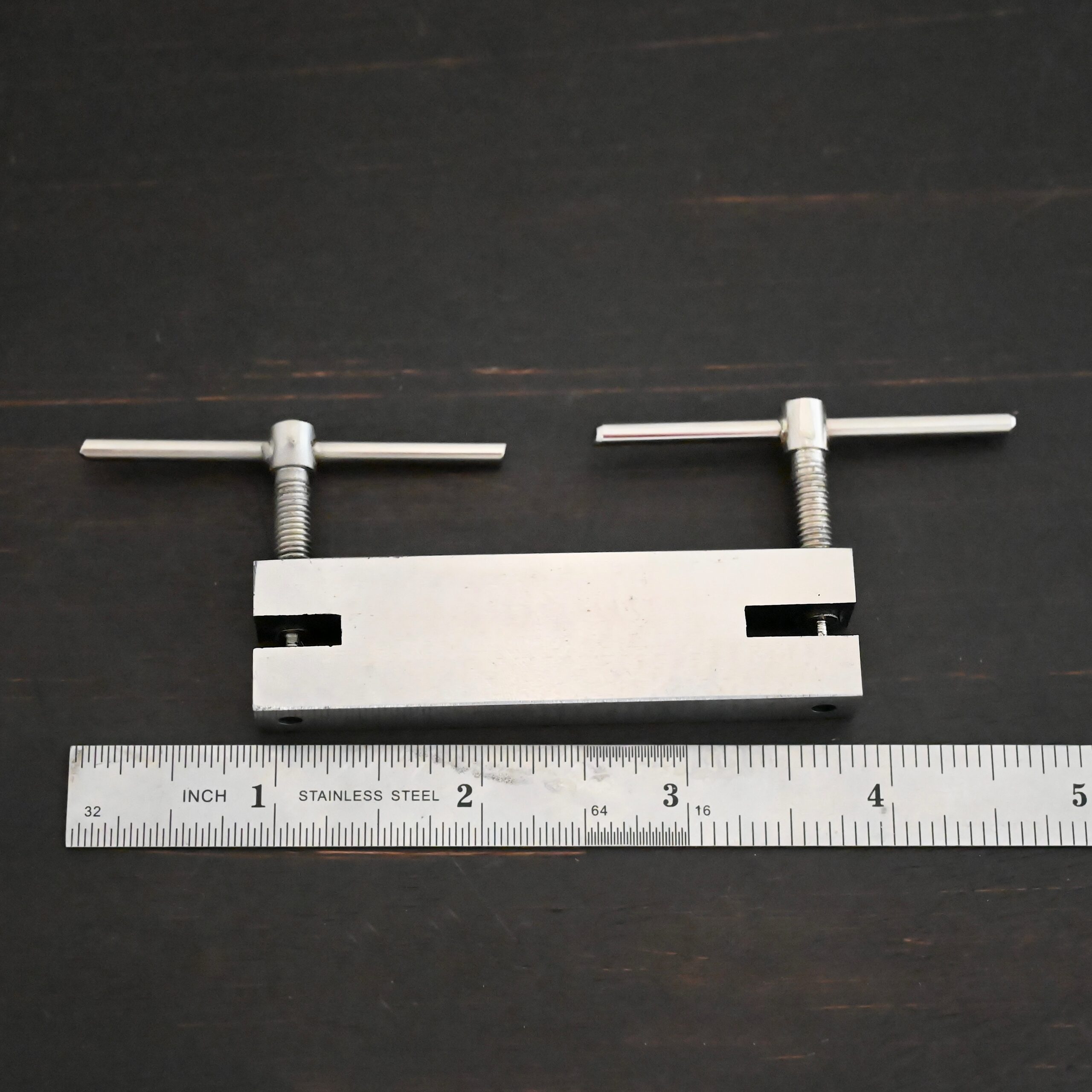 Stainless Steel Hole Punch & Twist Tool shown by ruler