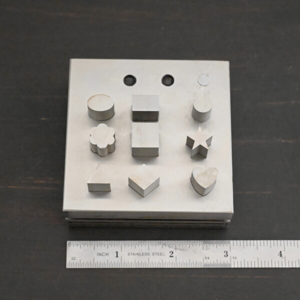 Stainless Steel Disc Cutter Showing all punches shown next to ruler