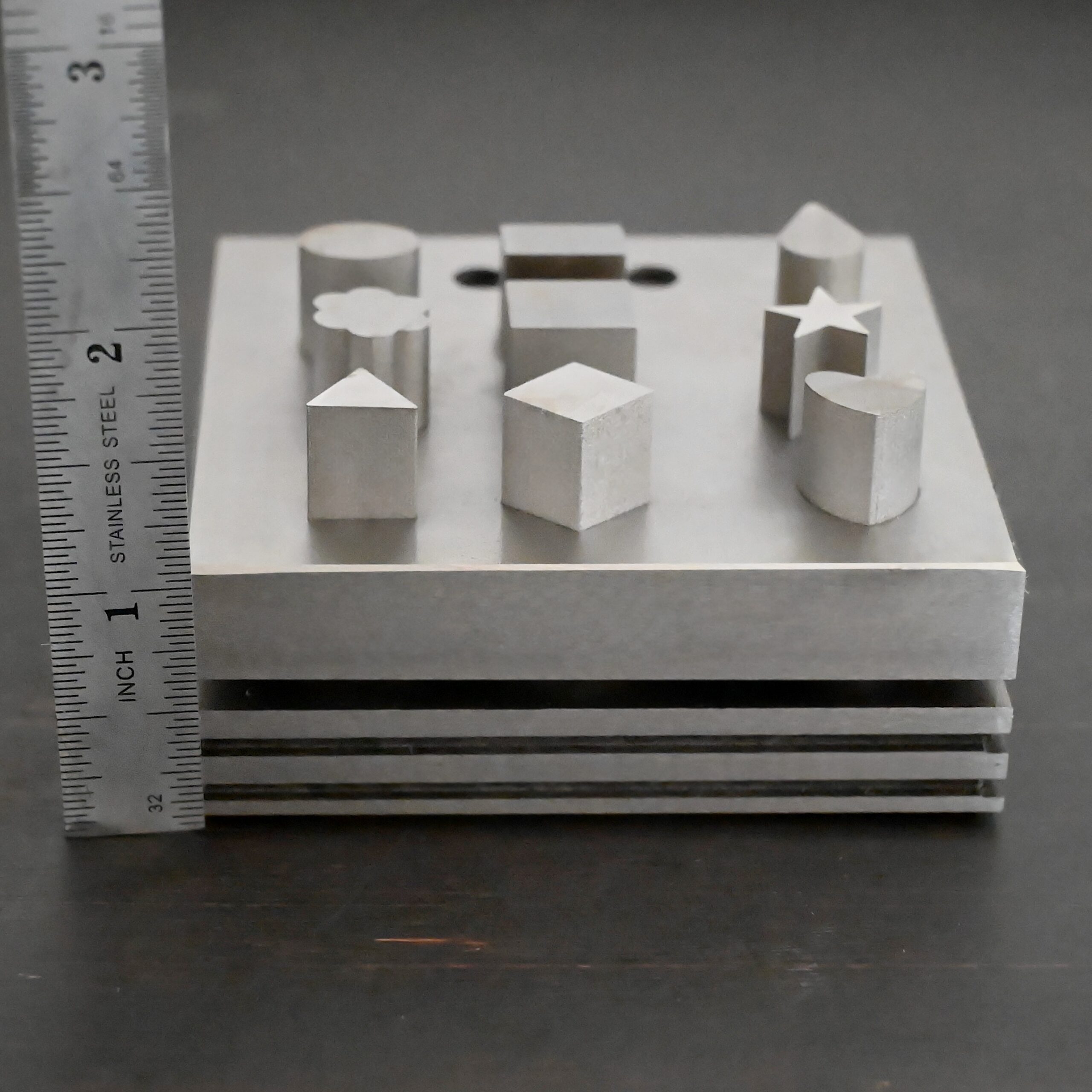 Stainless Steel Disc Cutter Showing all punches shown next to ruler