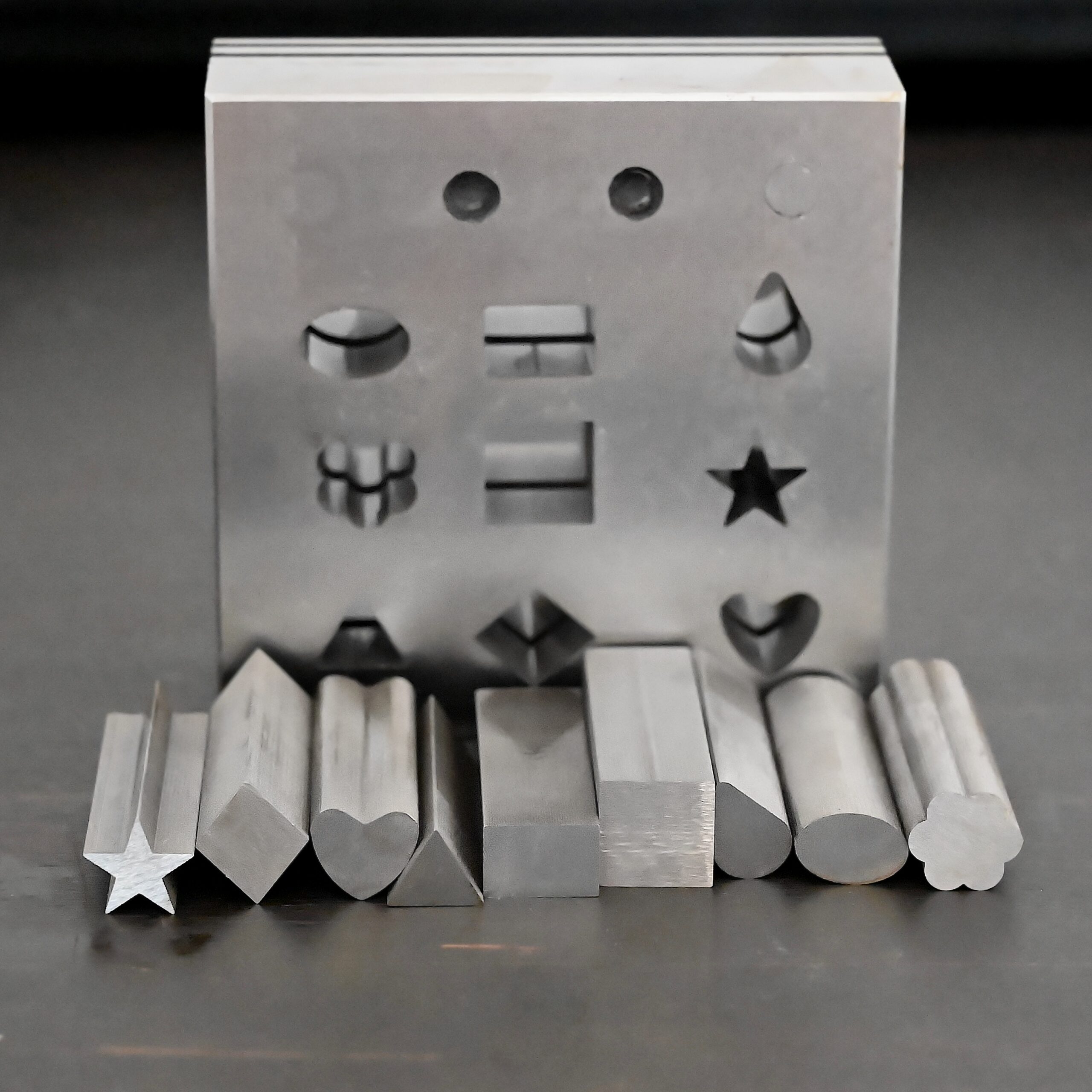 Stainless Steel Disc Cutter Showing all punches shown on dark background