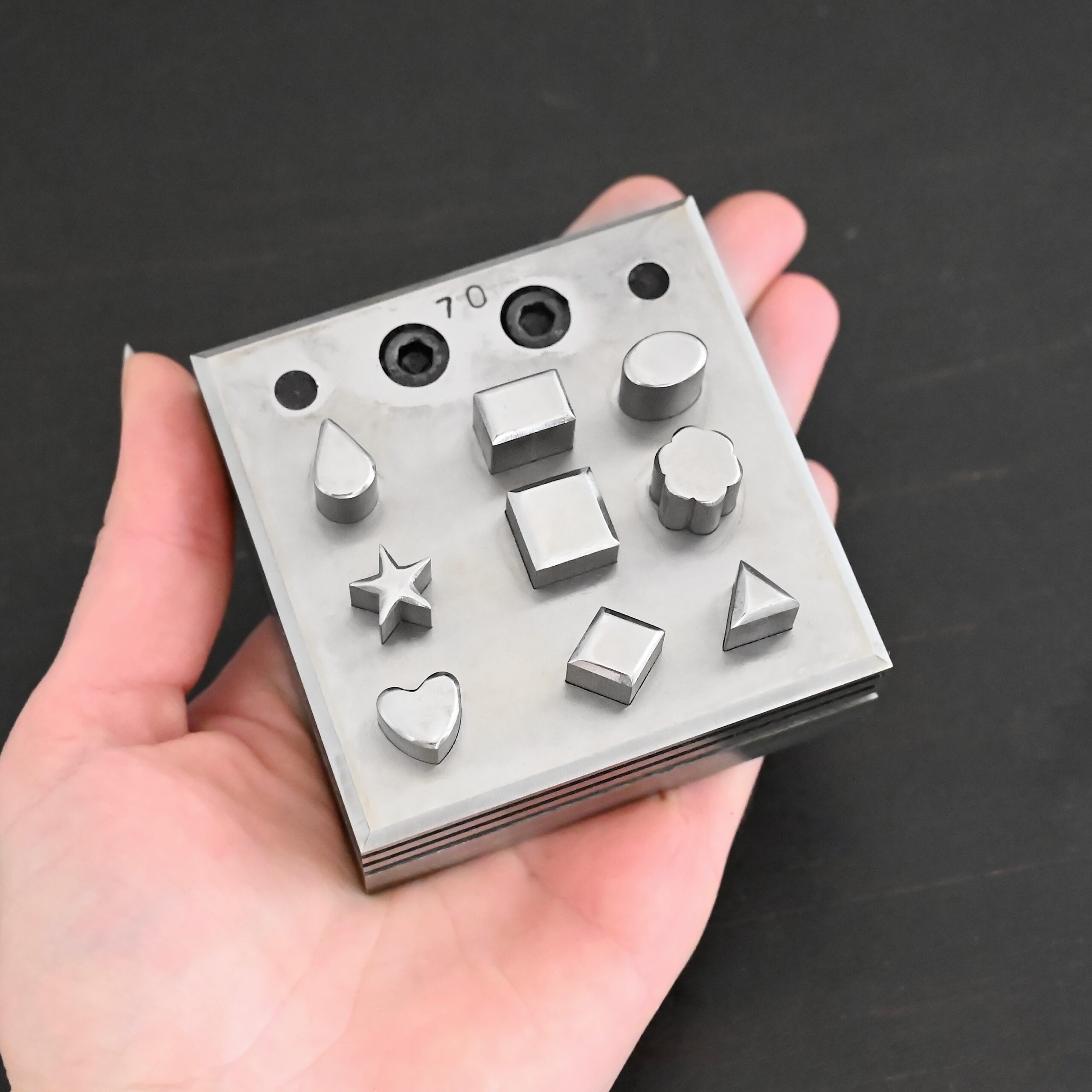 Stainless Steel Disc Cutter Showing all punches shown in hand