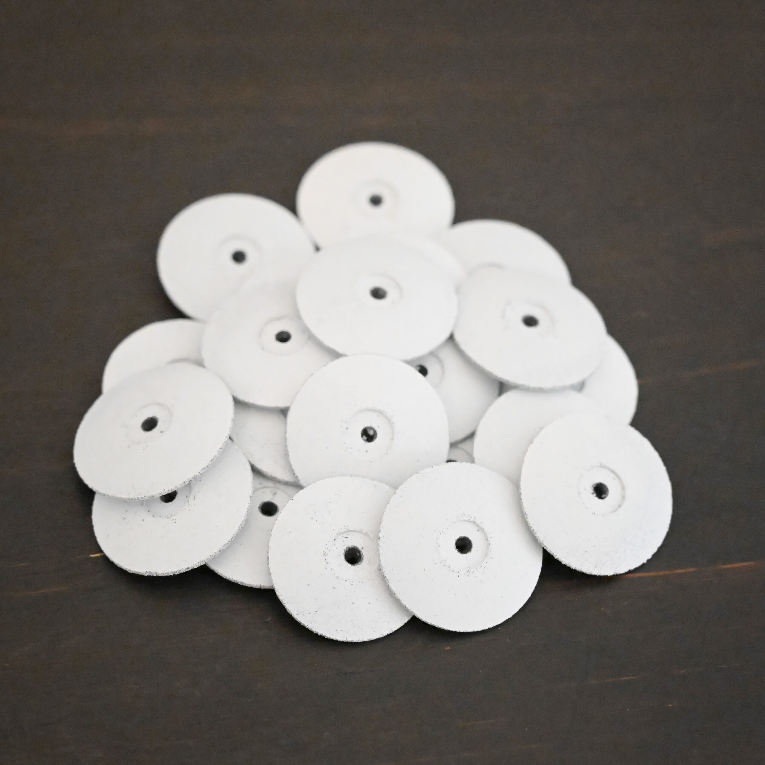 White Polishing Wheels shown on dark background