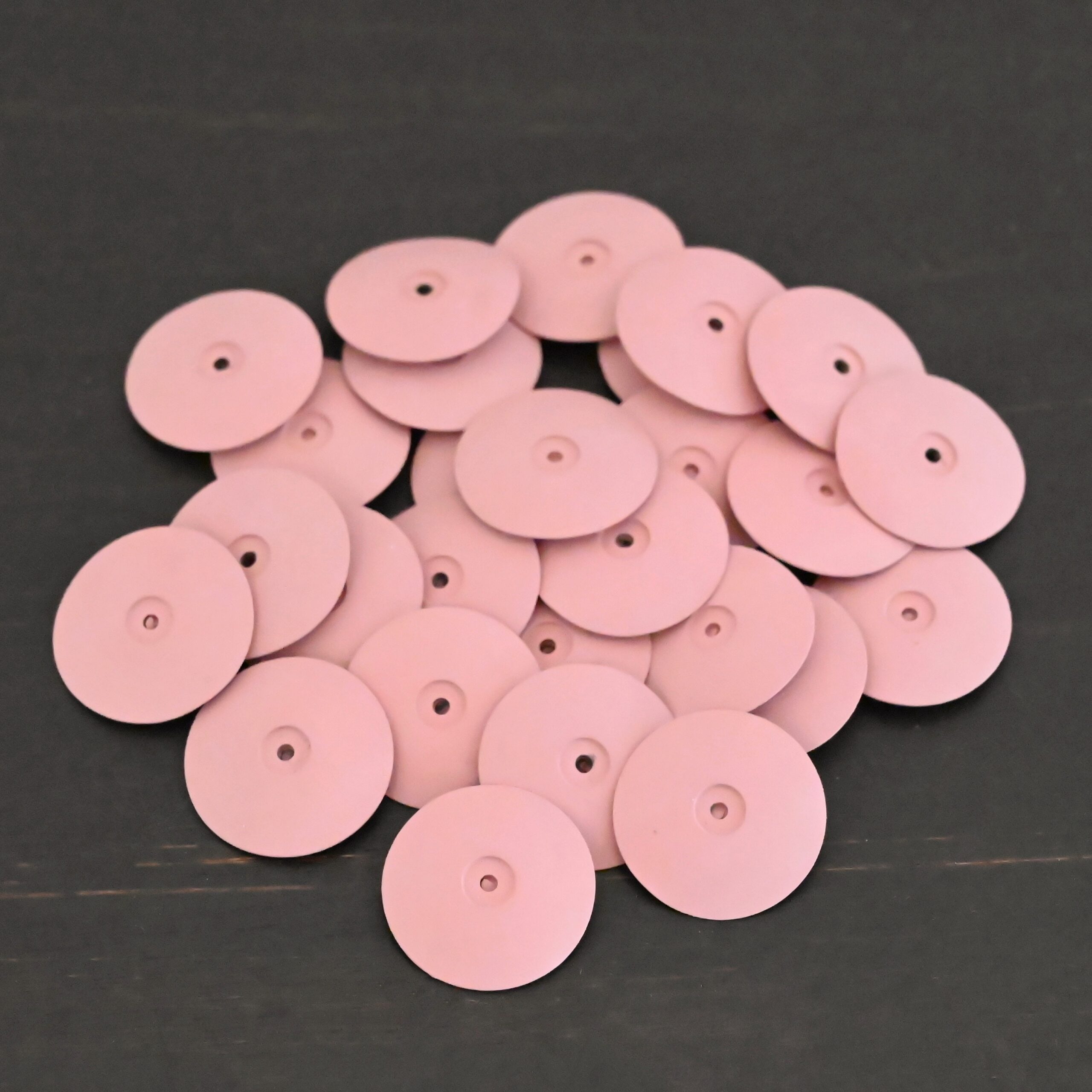 Pink Polishing Wheels shown on dark background