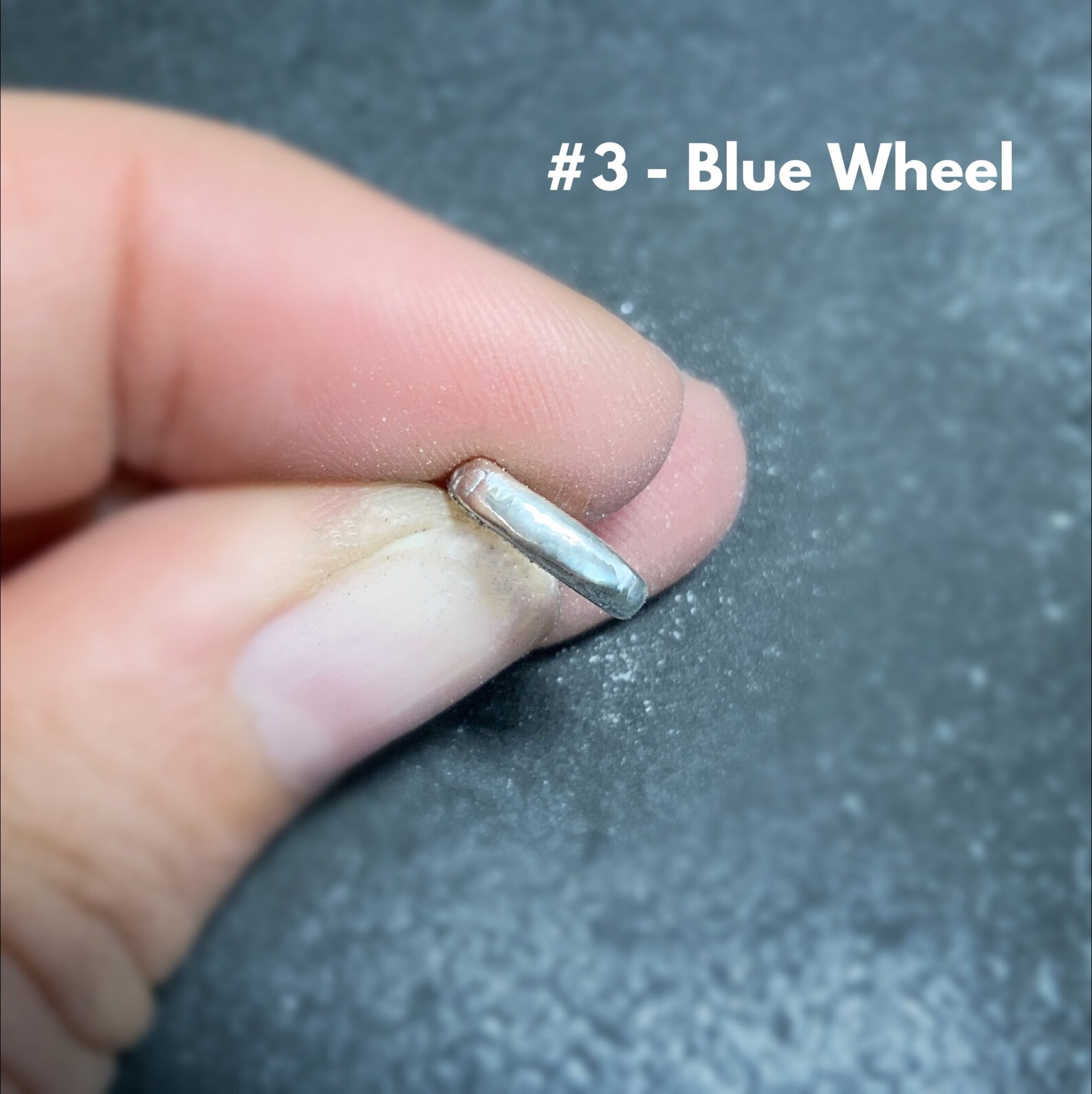 Shows after using the #3 blue wheel on stainless steel clasp shown in hand