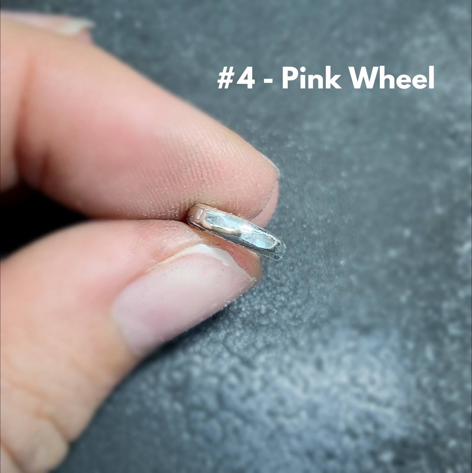 Shows after using the #4 pink wheel on stainless steel clasp shown in hand