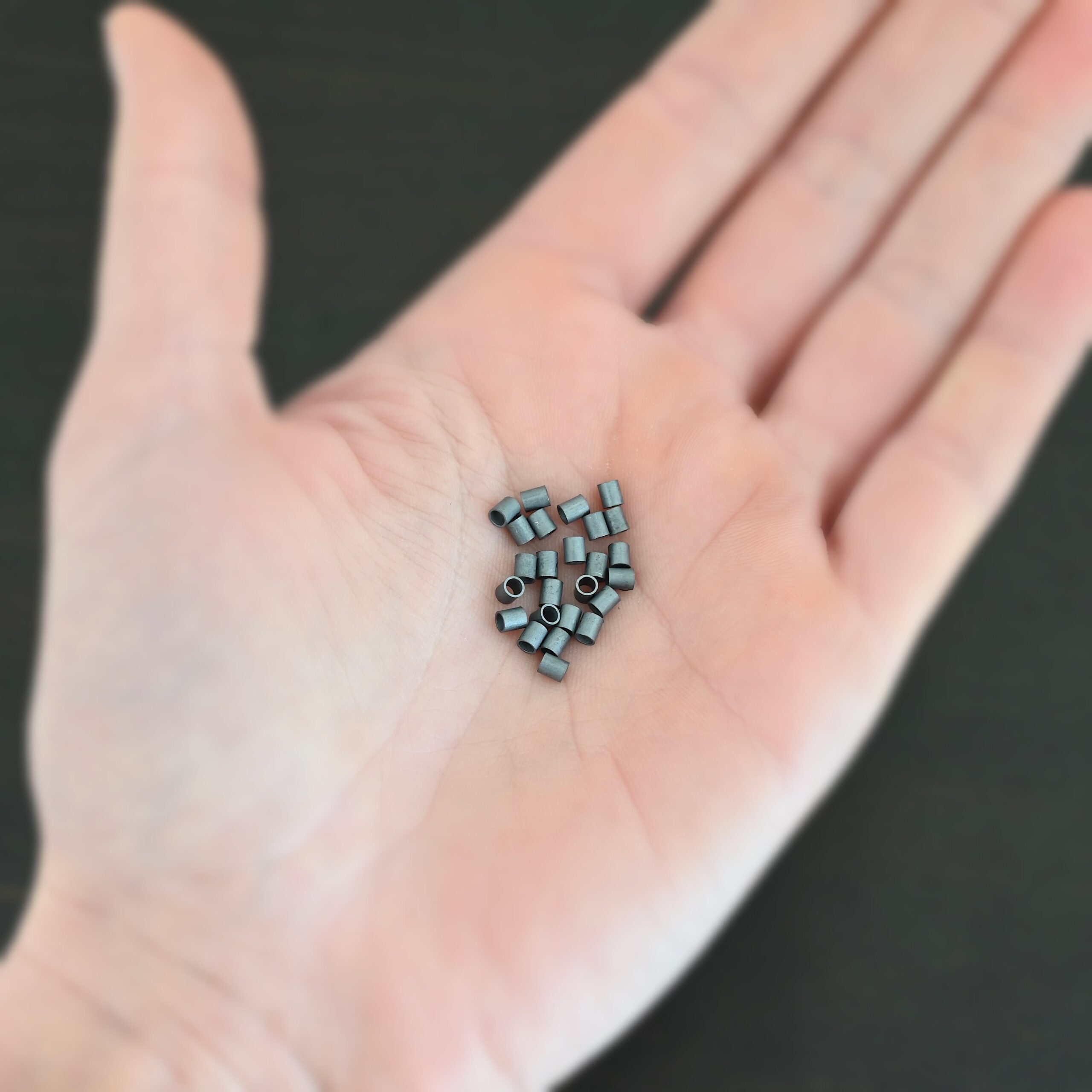 Silver oxidized 3mm crimp shown in hand