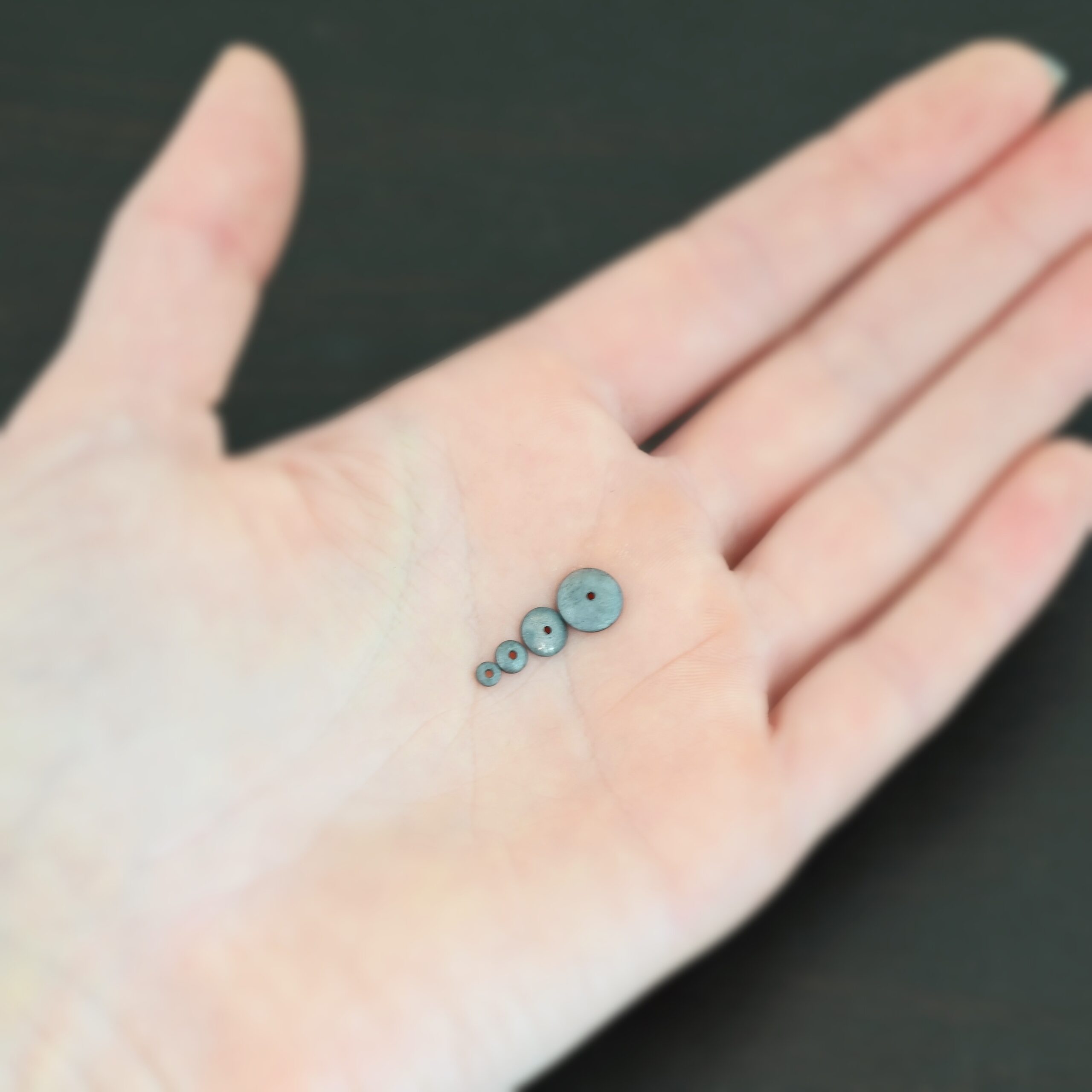 Silver oxidized bead caps all sizes shown in hand